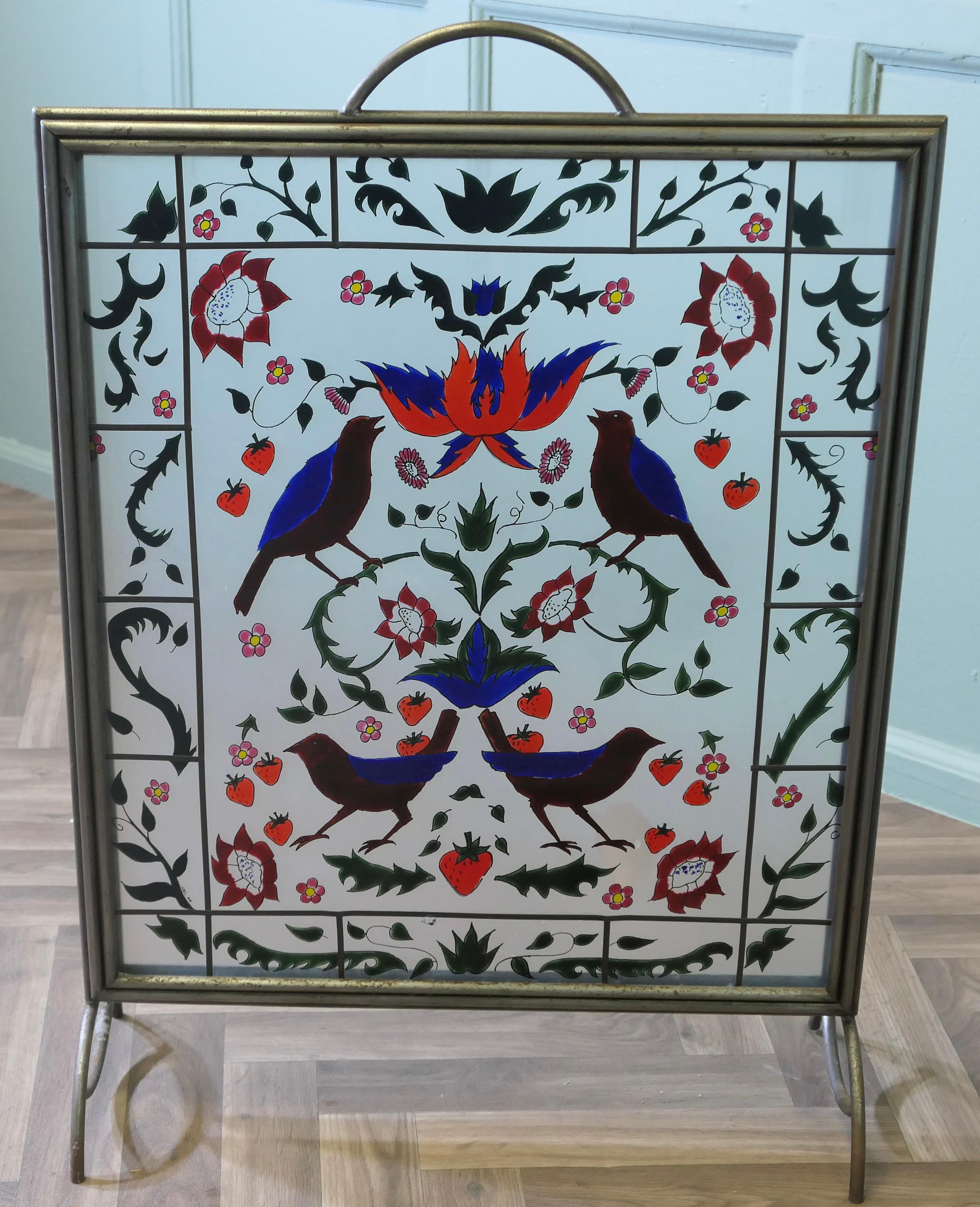 A Victorian Art Nouveau Painted Glass Fire Screen

This is a most decorative Fire Screen it is set in a heavy steel frame, the Mirror is painted with Birds and Flowers, it has a brass overlay on one side
The screen is in good sound condition, it is