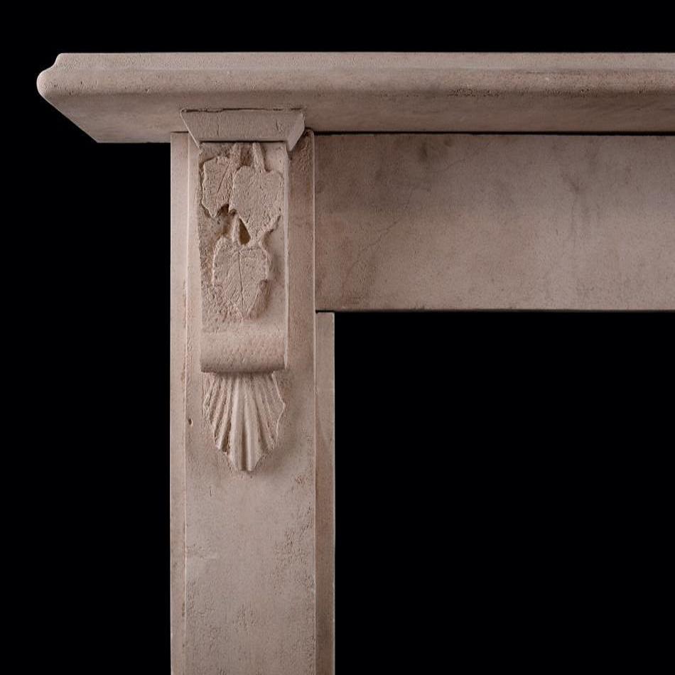 A Victorian Bath stone fireplace. The flat fronted jambs with scrolled corbel brackets carved with leaves, with moulded shelf above. English, mid-late 19th century.

Additional information:
Shelf Width: 1513 mm / 59 ⅝