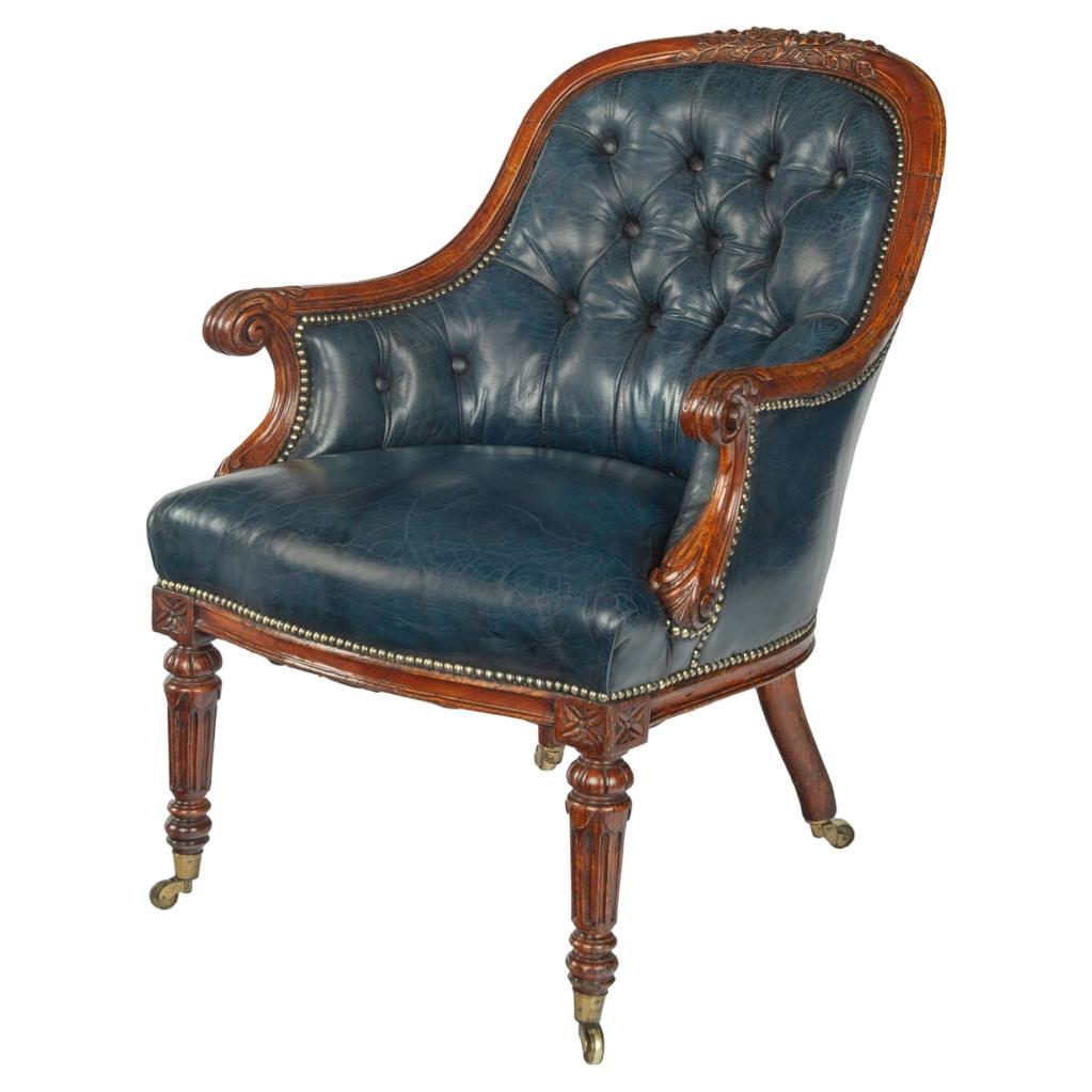 A Victorian blue leather oak library chair