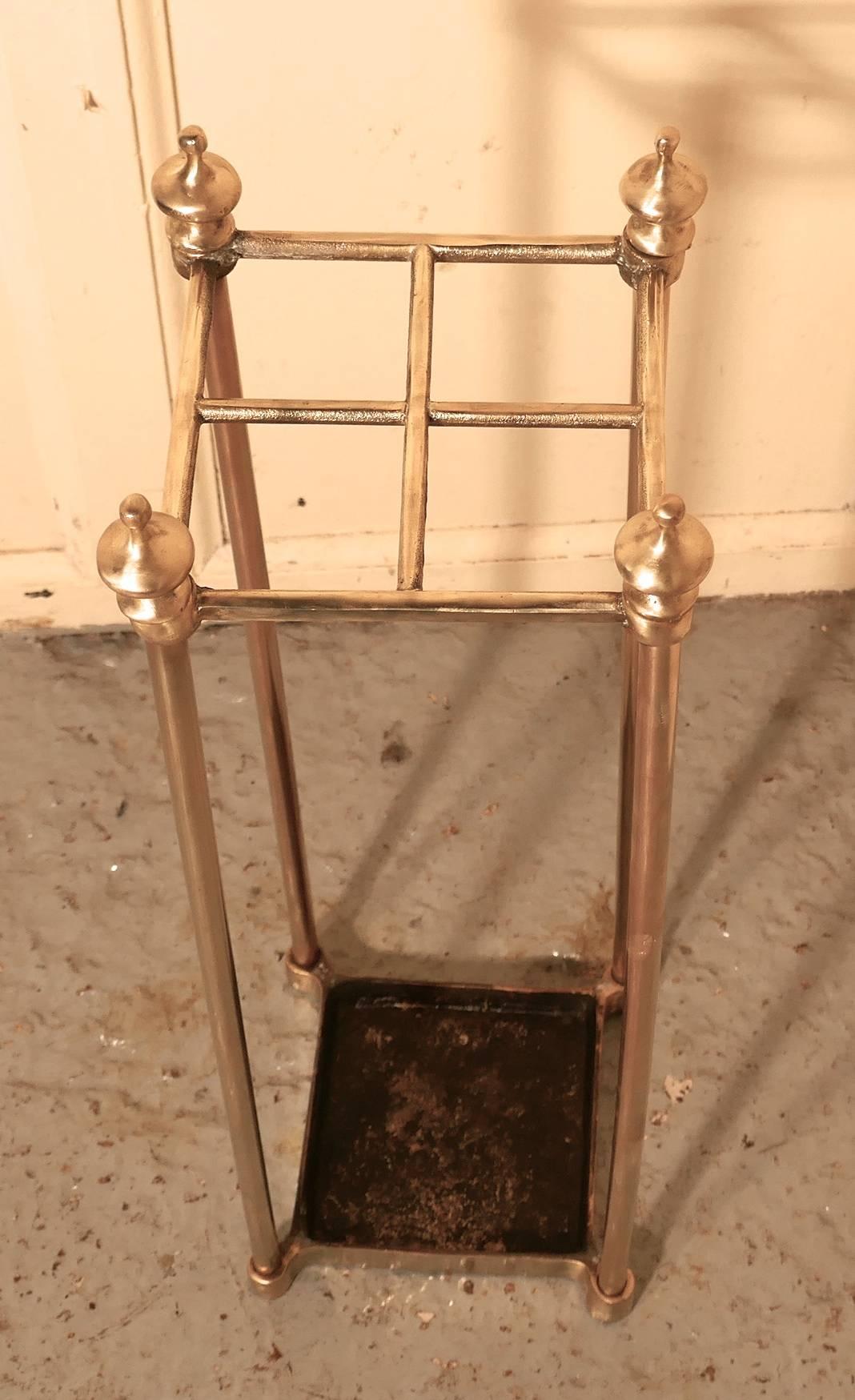 A Victorian brass and cast iron walking stick stand or umbrella stand

A charming piece, the stand has a brass top divided into 4 sections to hold either walking sticks or umbrellas, the heavy iron base which is also the drip tray 
The stand is