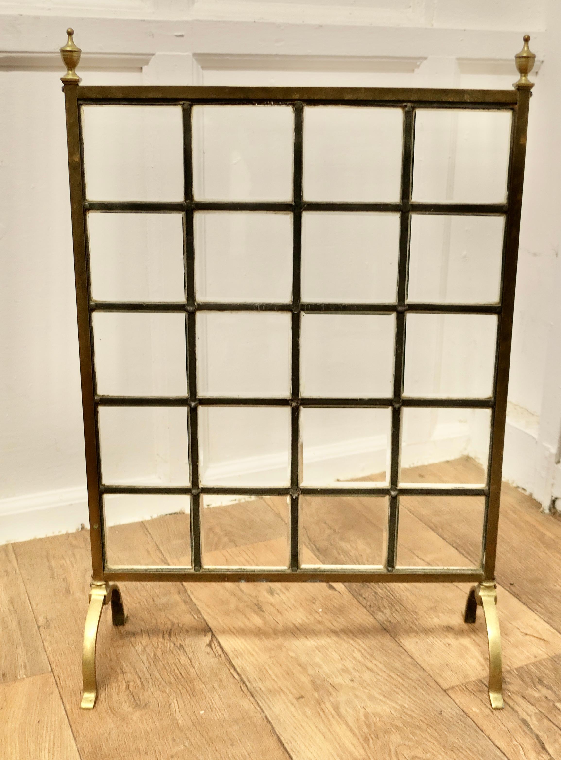A Victorian Brass and Glass Art Nouveau Fire Screen

This is a most charming Fire Screen in the art nouveau style, it has superb  brass finials and is set on brass feet, the centre of the screen is made in square bevelled glass panels.
The screen is