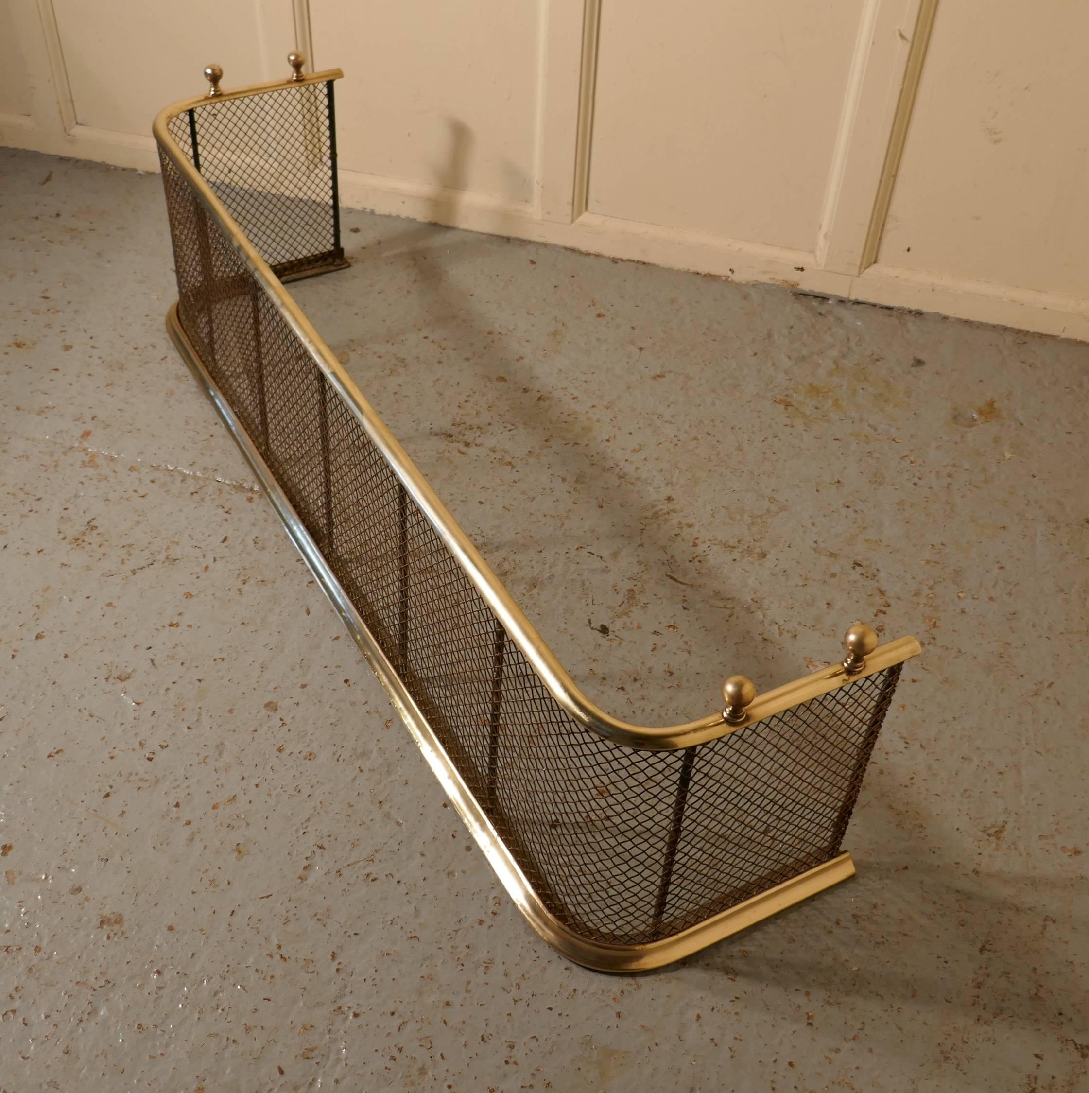 A Victorian brass and iron Fender or Fireguard
 
A Victorian antique fire guard often known as a Club Fender, the iron guard has wire mesh and brass rails top and bottom, it has brass knobs on the top, the fender is in good all round condition