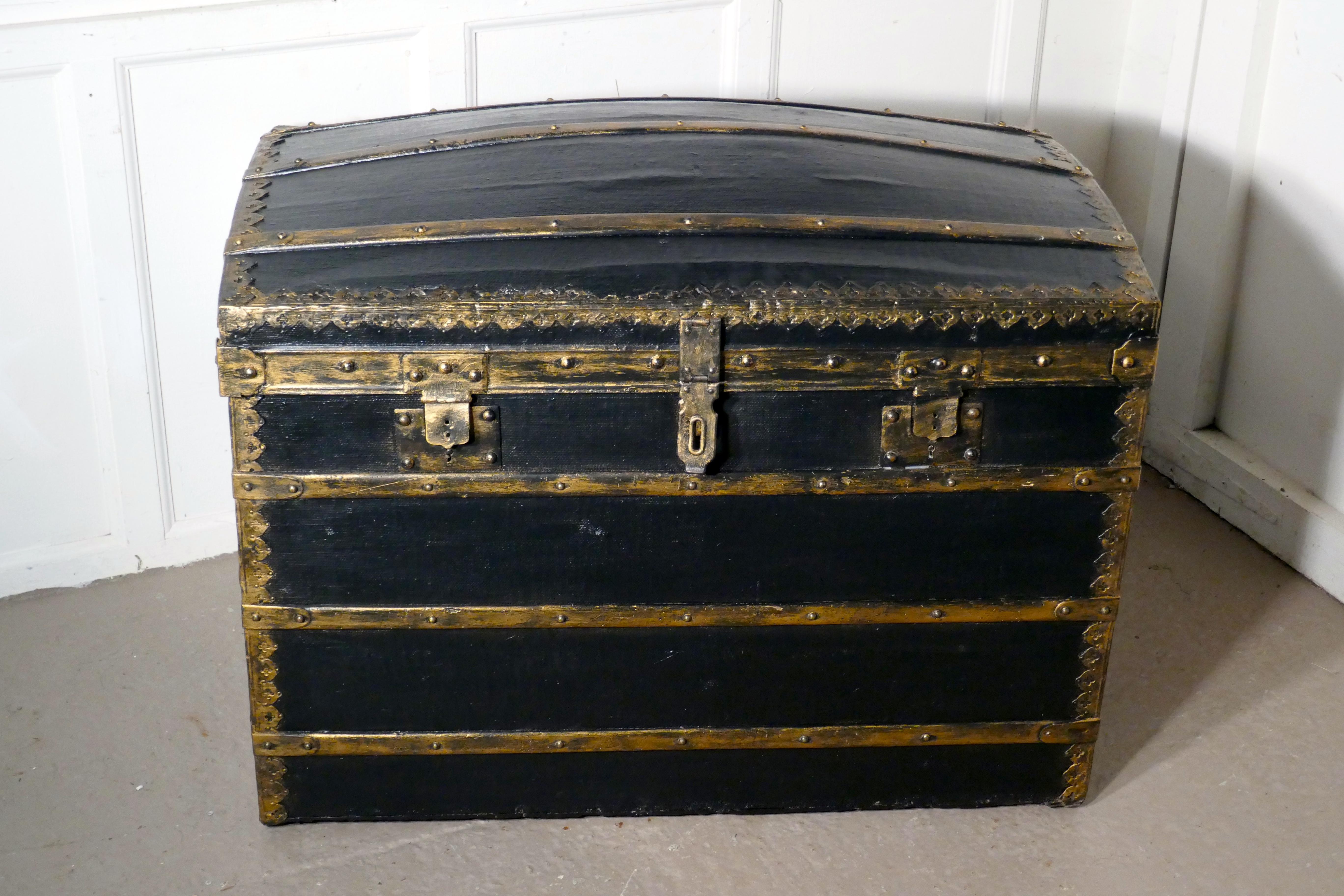 A Victorian canvas dome top traveling trunk


This trunk has a wooden carcass, and it is covered with black canvas oil cloth, it has Oak banding over the top, front and back with brass and iron strengthened corners, the metal work has a gilded