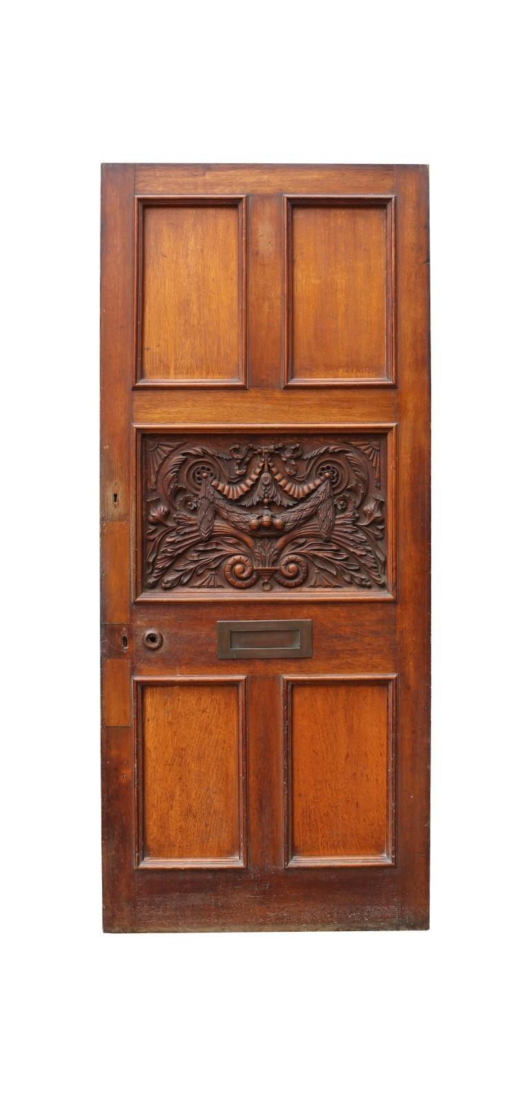 A good quality reclaimed door, the centre panel deeply carved with foliage and swag decoration.