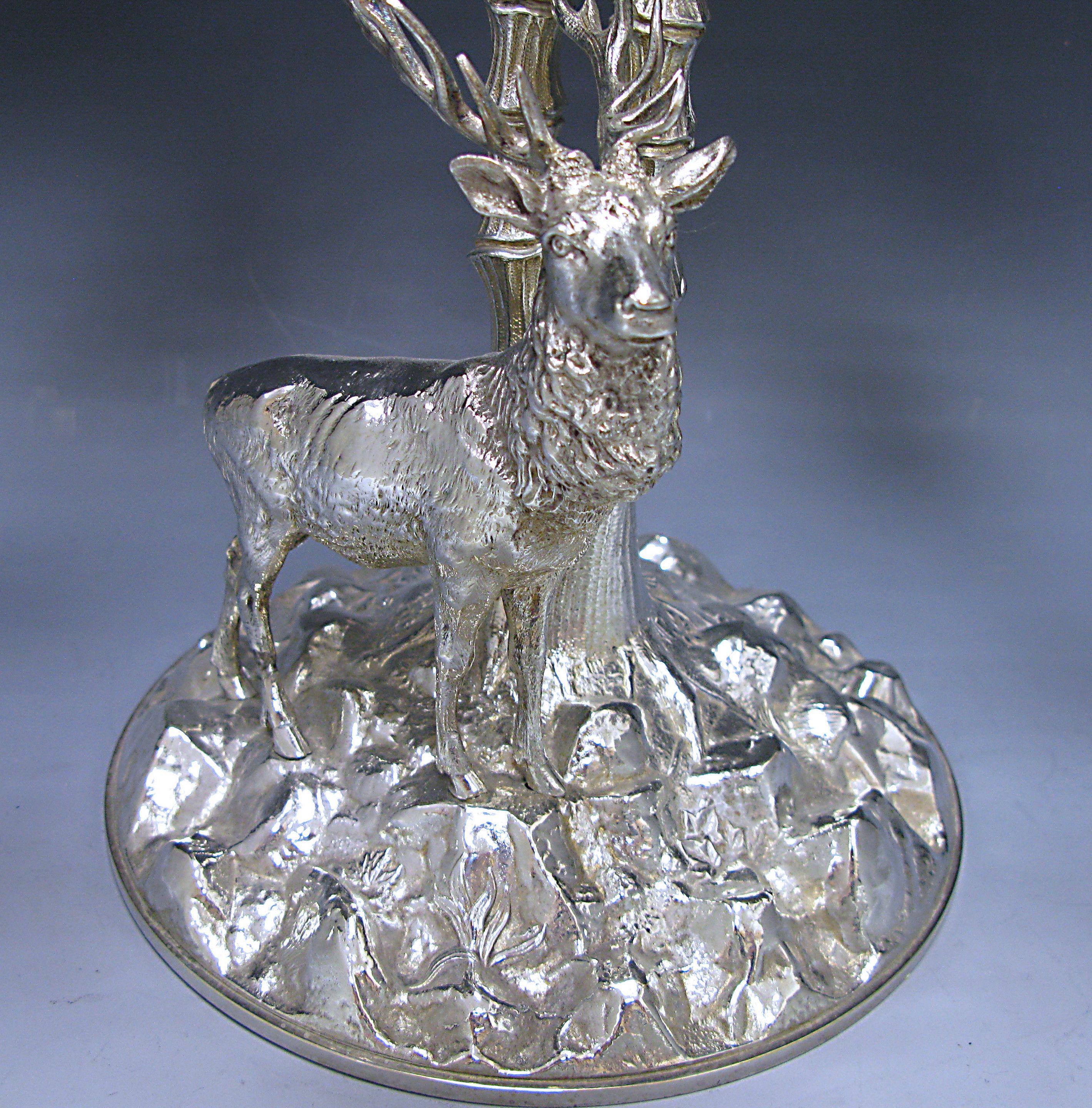 Late 19th century Victorian centrepiece composed of silver plated , cast in the form of a stag standing by two palm trees. Eight branches with leaves at their ends form the base to hold a glass dish. 

Made by WM F.

Measures: Height 15.75