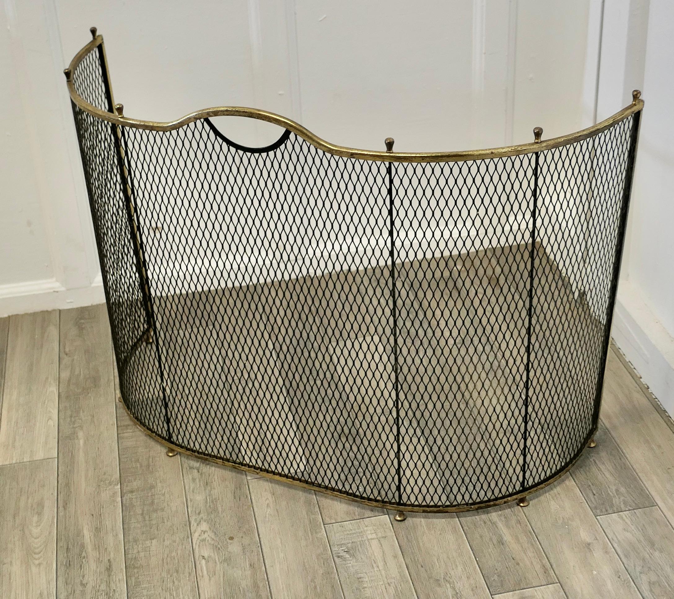 A Victorian curved brass and iron nursery fire guard


A Victorian antique fire guard often known as a nursery guard as it completely surrounds the fire.
The iron guard has a diamond mesh infill and a very pretty curved shaped with a brass