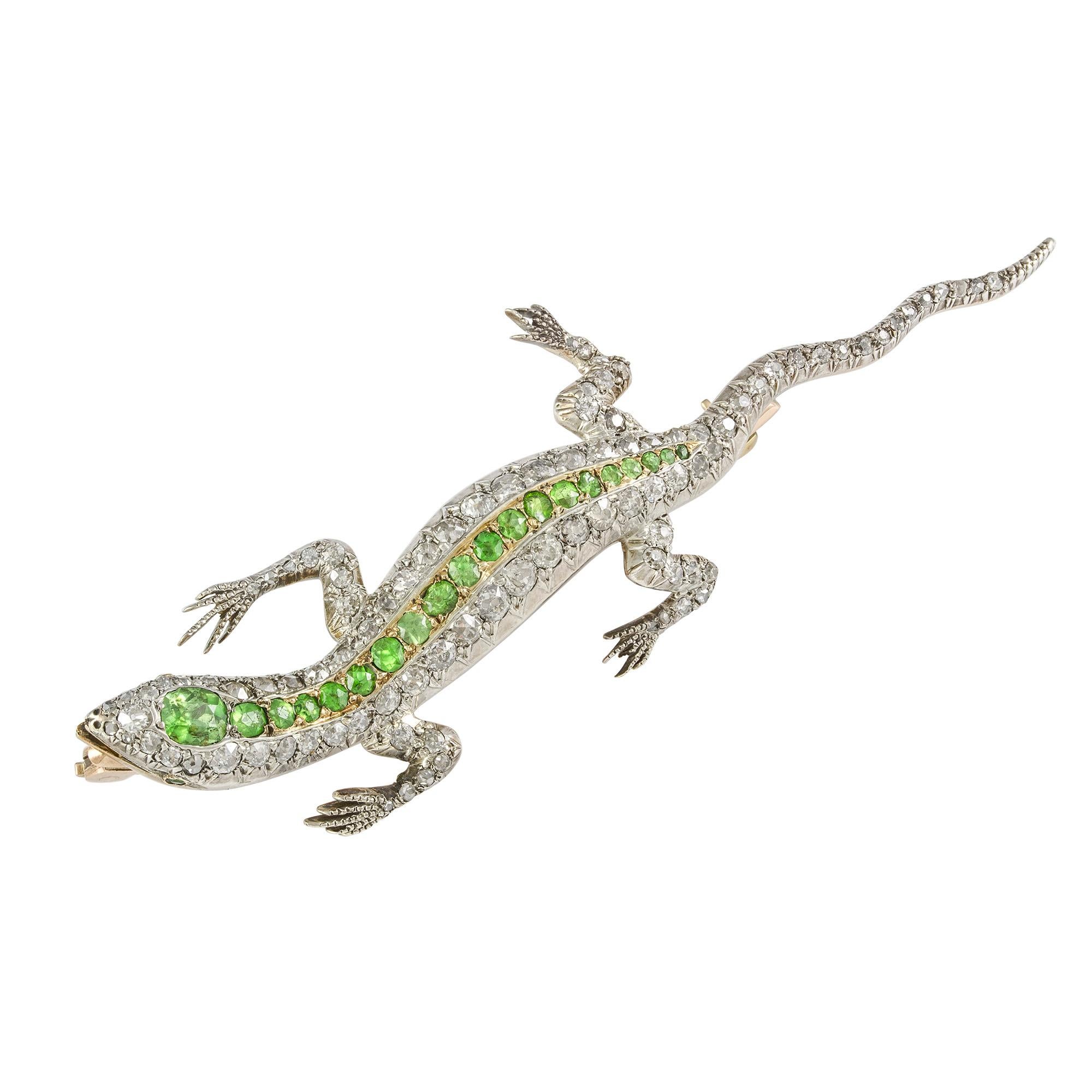 A Victorian demantoid garnet and diamond lizard brooch, the writhing lizard encrusted with old brilliant-cut diamonds, estimated to weigh a total of 2.65 carats, silver claw-set to a yellow gold mount, set with a central streak of round-shaped