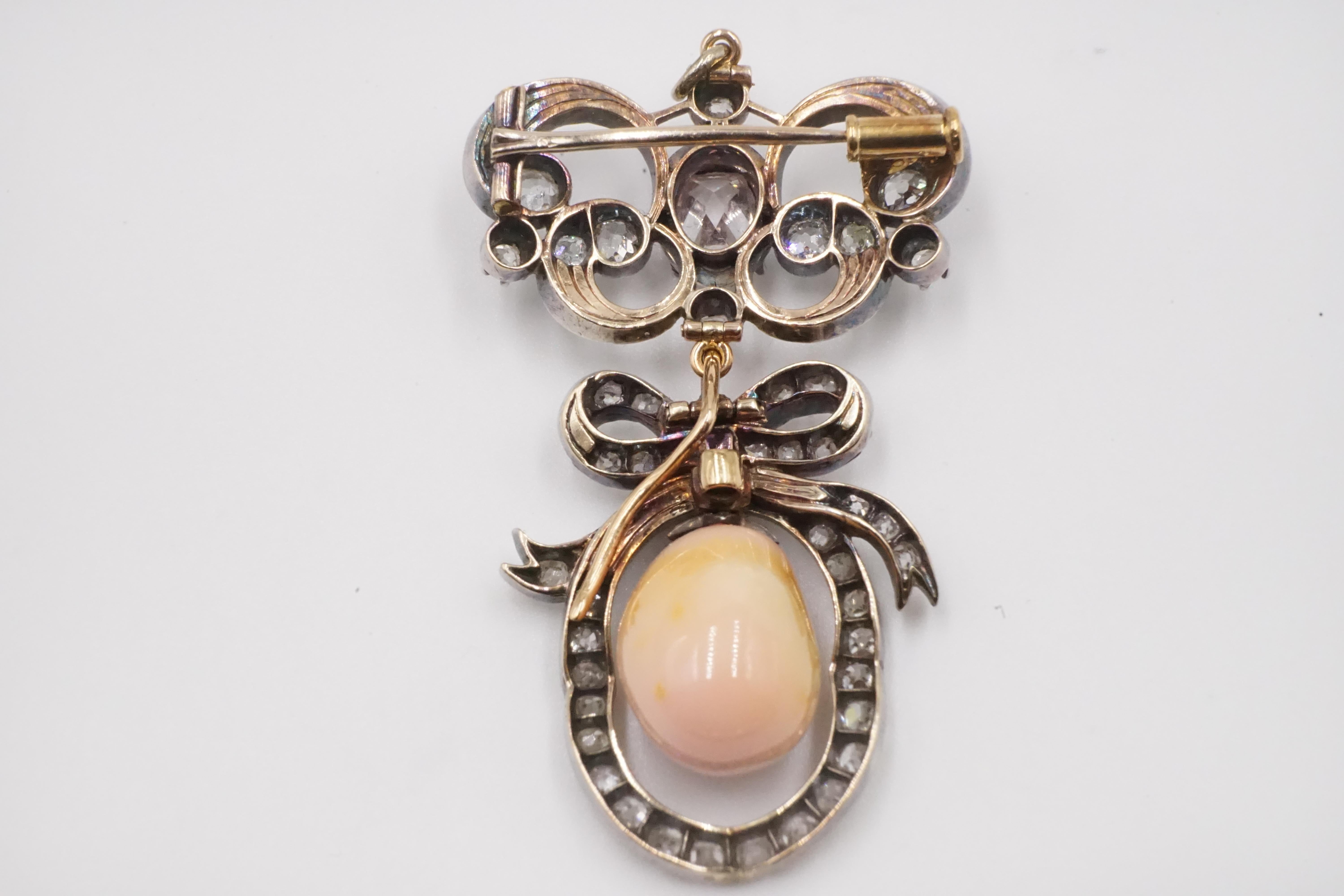 A Victorian Detachable Natural Queen Conch Pearl Gold Brooch with Cert. 

When detached the lower section with the pearl can be used as a pendant and the upper section can be wore as a stand alone brooch or attach to other brooch parts.

Silver on