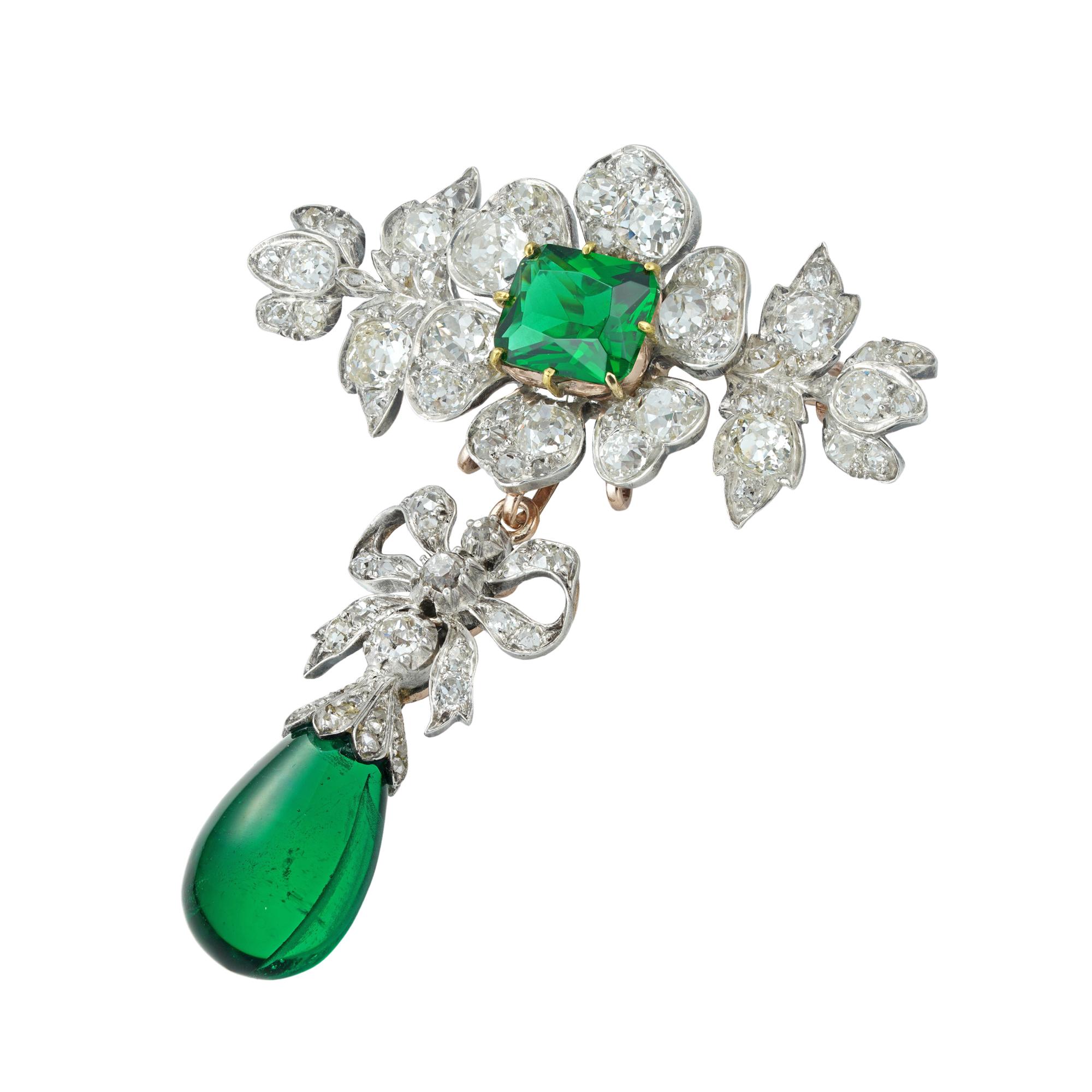 A Victorian diamond and green-paste brooch, the brooch in the form of a flower with a cushion-shaped green paste to the centre surrounded by six petals set with old European-cut diamonds, within diamond-set foliate decorations, suspending a