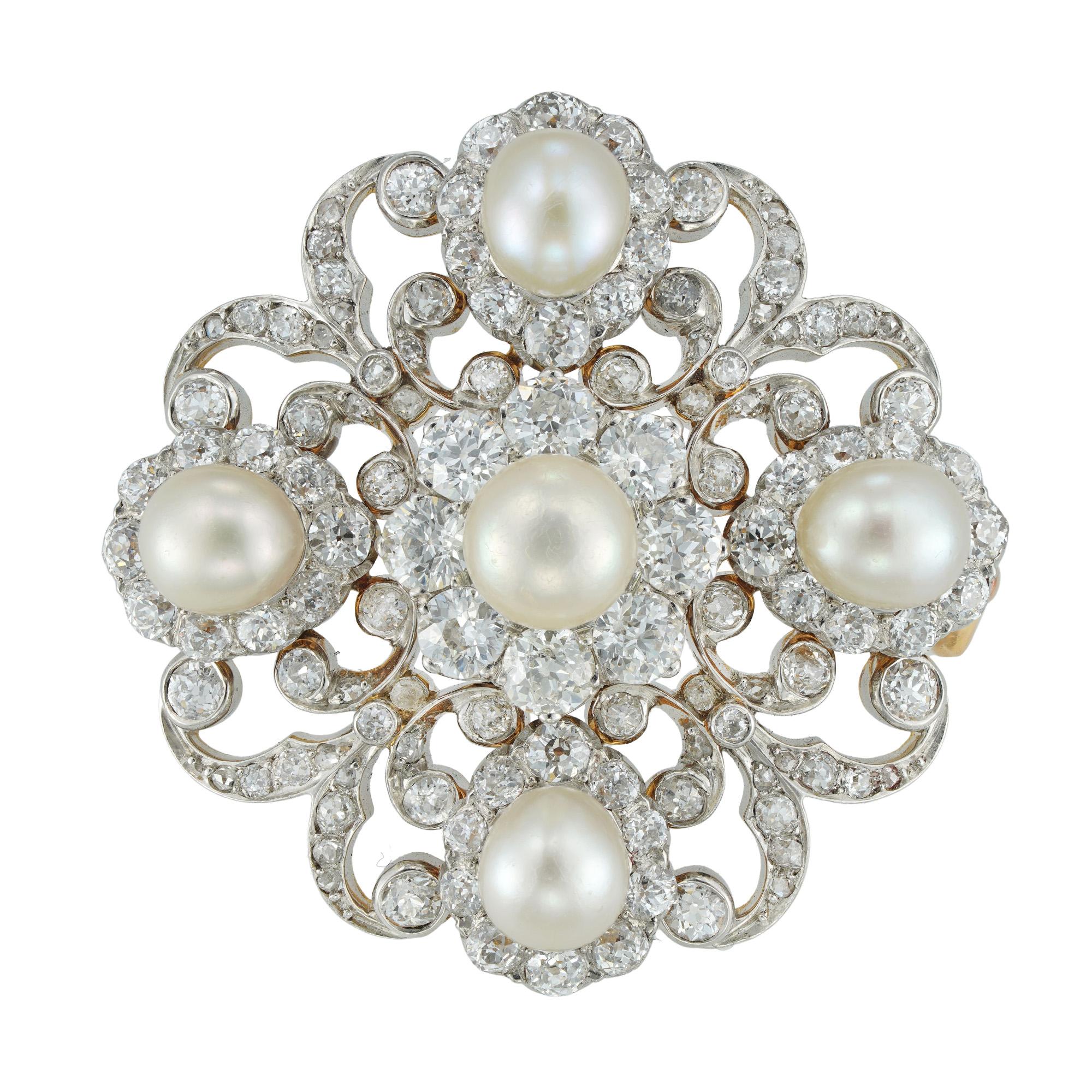 A Victorian diamond and pearl scroll brooch, the central pearl surrounded by a cluster formed of eight old brilliant-cut diamonds, set between four pear-shape pearl and diamond clusters with diamond-set scroll designs in-between, accompanied by GCS