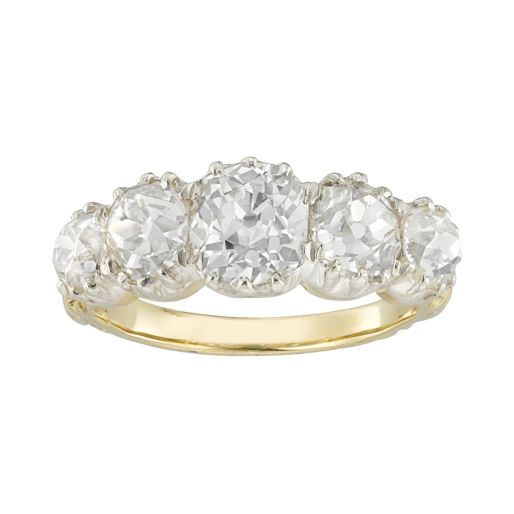 A Victorian five stone diamond ring, the five cushion shaped old European-cut diamonds estimated to weigh approximately 3¼ carats in total, assessed to be of I-J colour VS-SI clarity, all cut-down set in silver with a gold mount, with finely