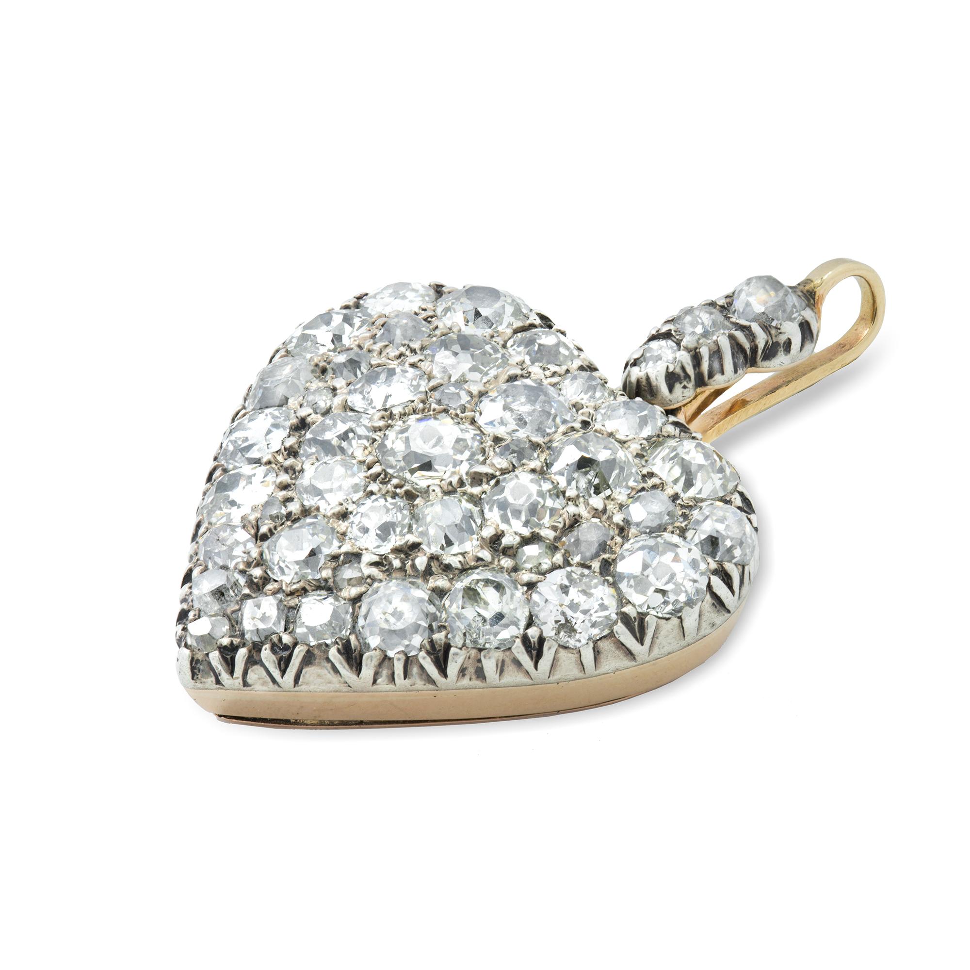 A Victorian diamond heart Pendant, pave'-set throughout with old European-cut diamonds, estimated to weigh 2.5 carats in total, all set in silver to pink gold back, with locket compartment to back and old brilliant-cut diamond-set pendant loop,