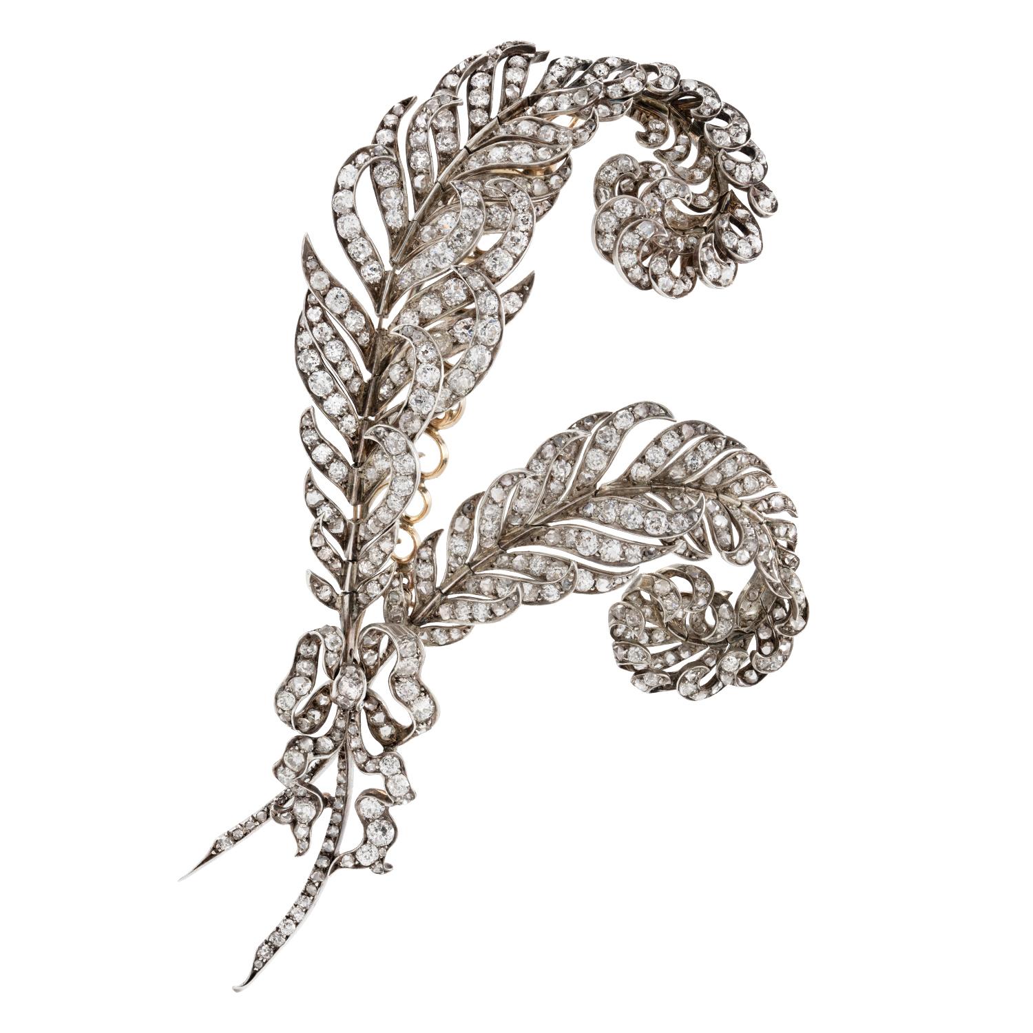 A Victorian diamond-set feather brooch, the two realistically carved feathers encrusted with old European-cut diamonds, tied with an old-cut diamond-set ribbon, the diamonds weighing approximately a total of 20 carats, all set in silver to yellow