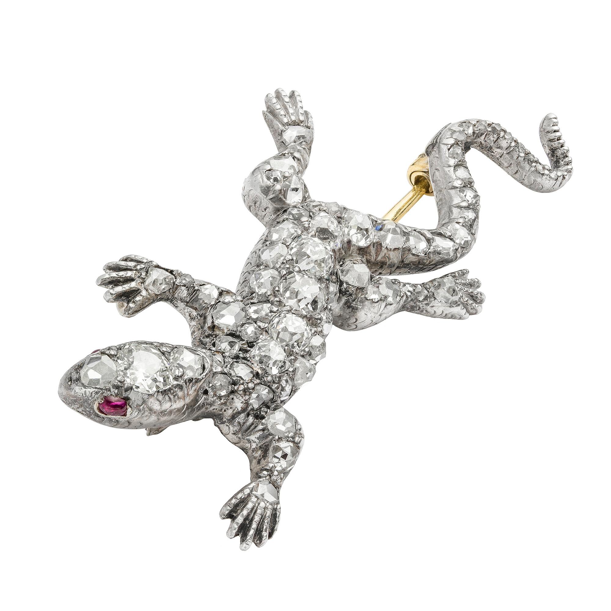 A Victorian diamond set lizard brooch, in the form of a lizard in motion, set throughout with old European and rose-cut diamonds with the largest to the head, the diamonds estimated to weigh 1 carat in total, the eyes set with cabochon-cut rubies,