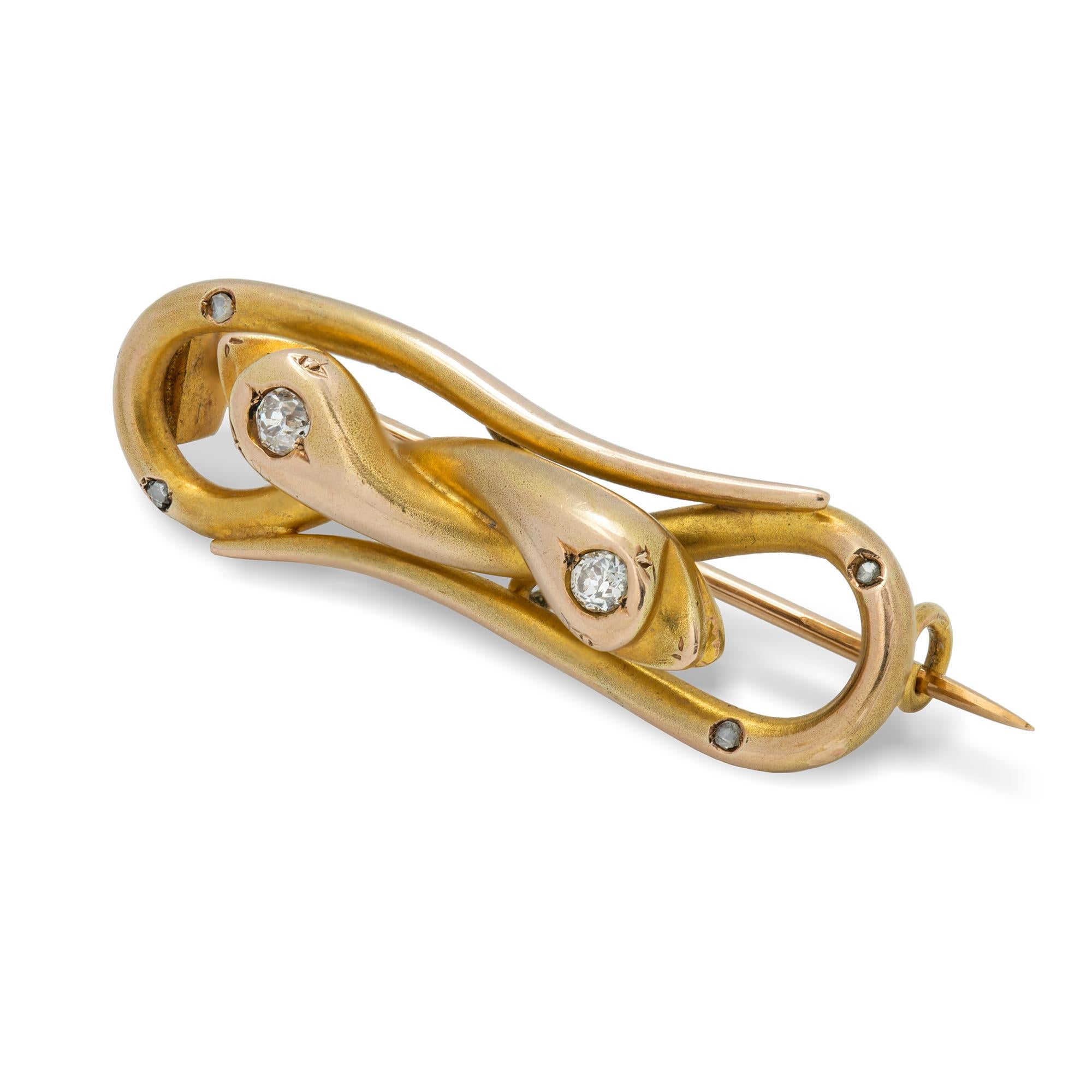 A Victorian double serpent yellow gold brooch, the two serpents curled in a figure-of-eight design, each head set with an old-cut diamond, all in yellow gold with satin finish and gold brooch fitting, circa 1860, bearing later French hallmark for