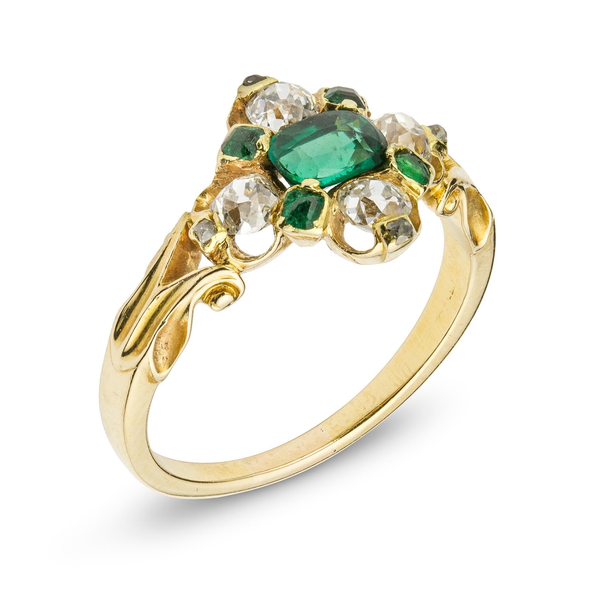 A Victorian emerald and diamond cluster ring, centred a mixed-cut oval emerald estimated weight 0.4 carats surrounded by four old round-cut diamonds estimated total weight of 0.6 carats set between four mixed-cut emeralds, to scroll openwork