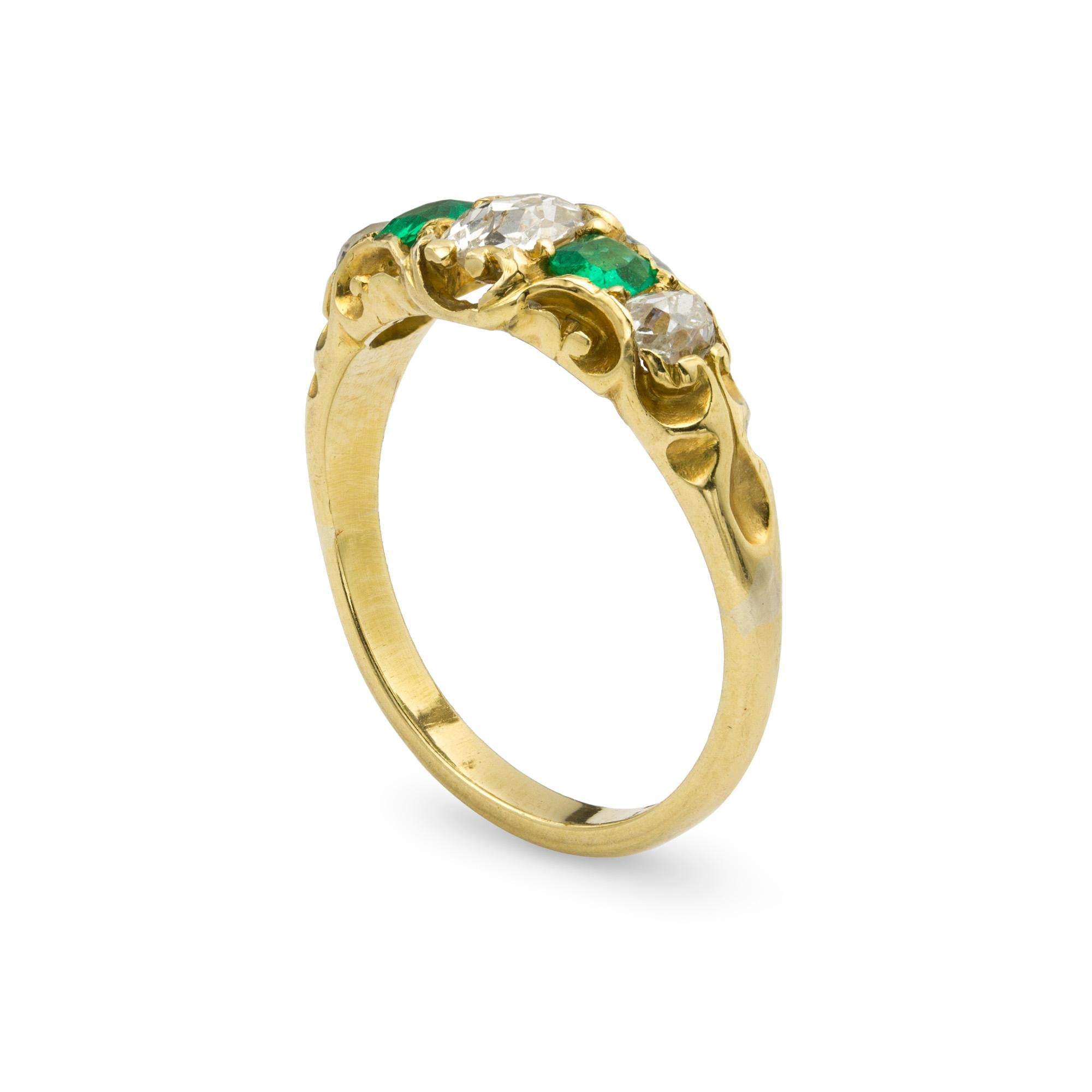 A Victorian emerald and diamond five stone gold ring, the ring set with three old-cut diamonds weighing approximately a total of 0.65 carats, and two cushion-cut emeralds weighing approximately a total of 0.25carats, all set in 18ct yellow gold