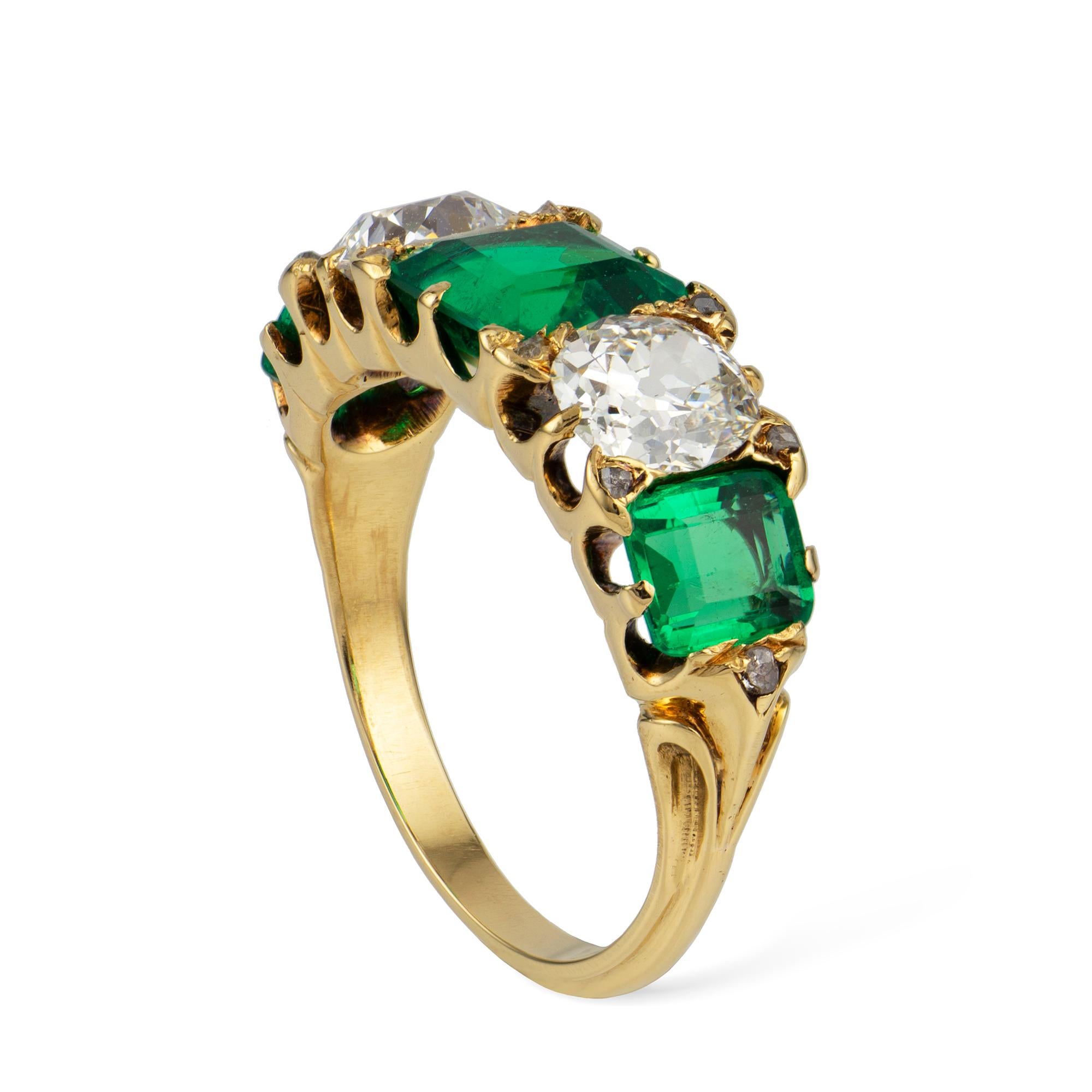 A Victorian emerald and diamond five-stone ring, alternately set with three square-set emeralds estimated to weigh a total of 2 carats, accompanied by GCS Report stating to be of Colombian origin, and two old-brilliant-cut diamonds, estimated to