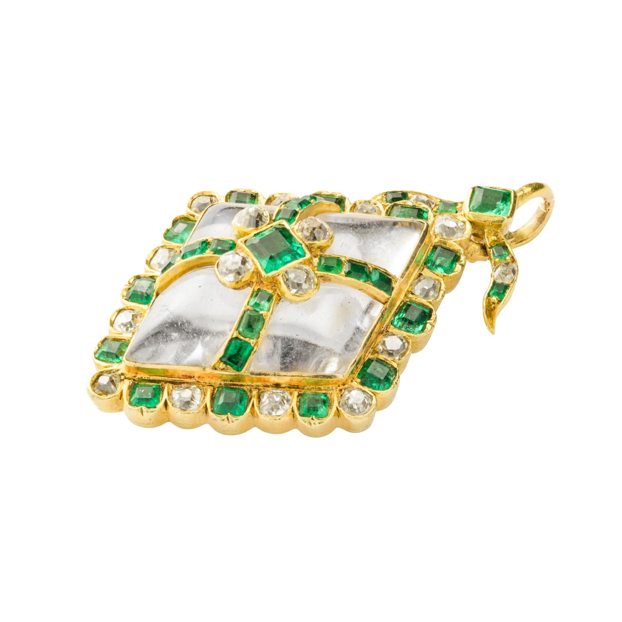 A Victorian emerald, diamond and crystal pendant, a lozenge shaped rock crystal, centrally applied with a square-cut emerald set between four old brilliant-cut diamonds, within an emerald-set cross to an alternate emerald and old brilliant-cut