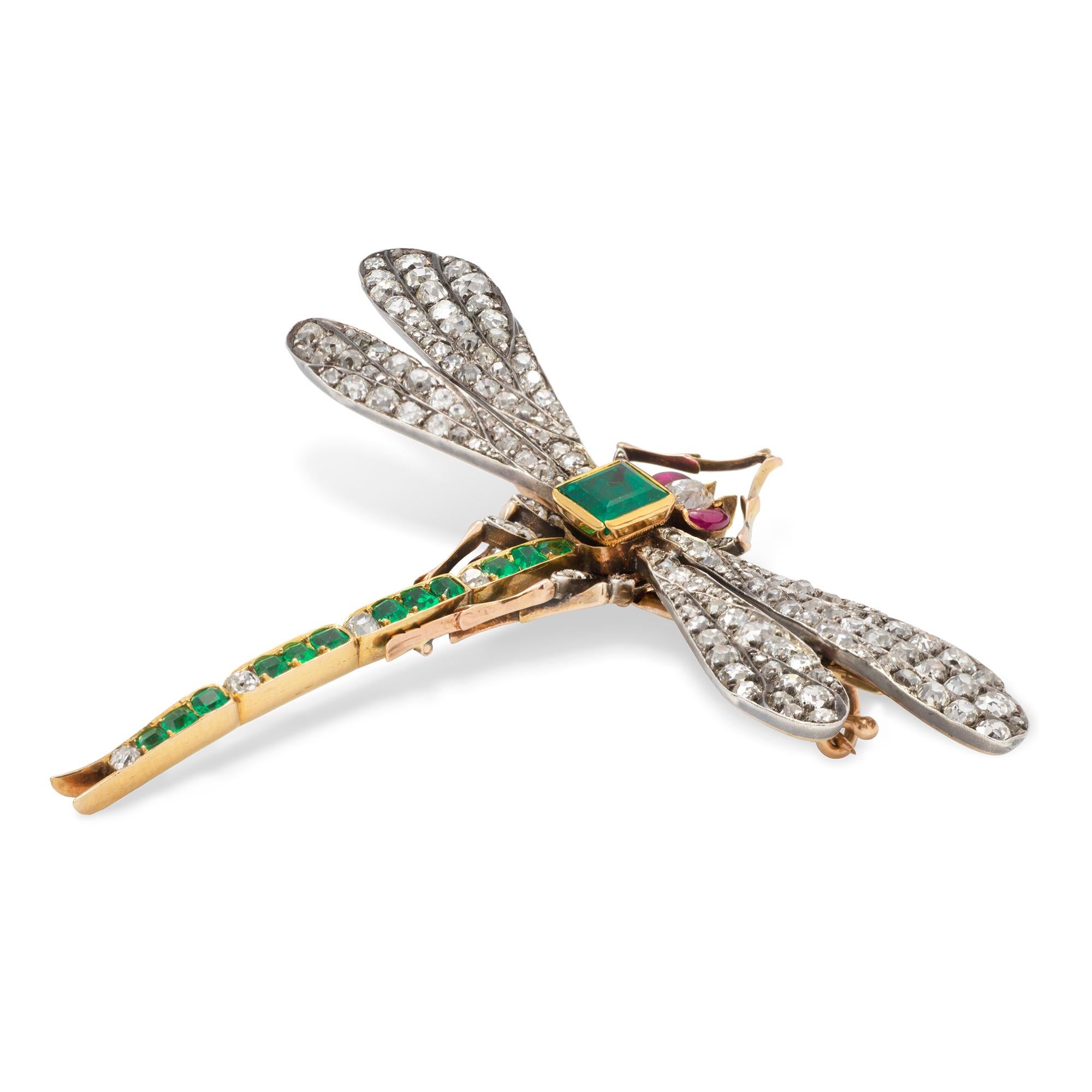 An antique Russian emerald and diamond dragonfly brooch, the body a square-cut emerald with estimated weight 0.6 carats, the tail set with twelve emeralds and four diamonds, the wings and legs set with old-cut and rose-cut diamonds, the eyes a pair