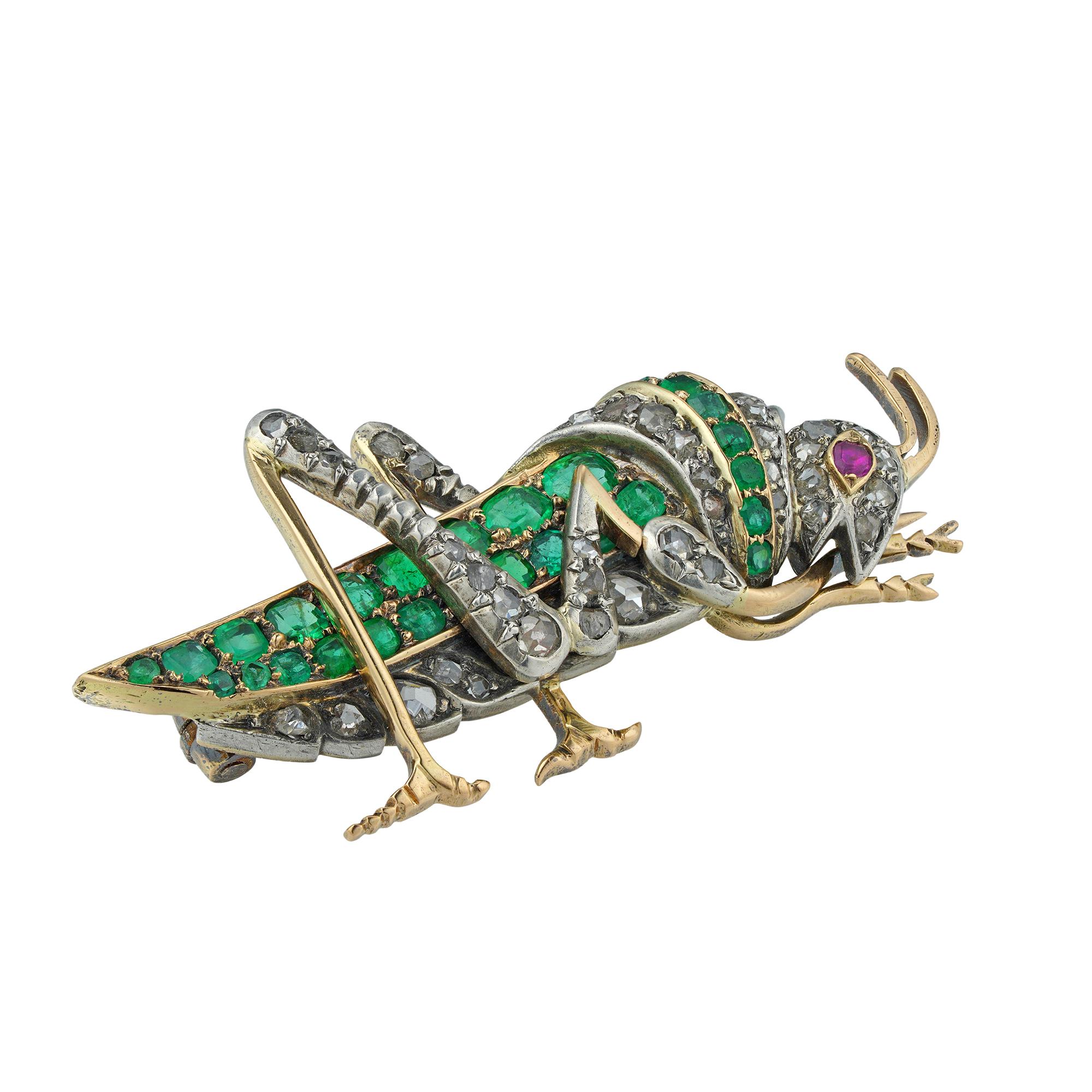 A Victorian emerald, ruby and diamond grasshopper brooch, the body, legs and head encrusted with thirty-five rose-cut diamonds estimated to weigh 0.4 carats, and twenty-seven square-cut emeralds, estimated to weigh 1.2 carats, a round faceted ruby