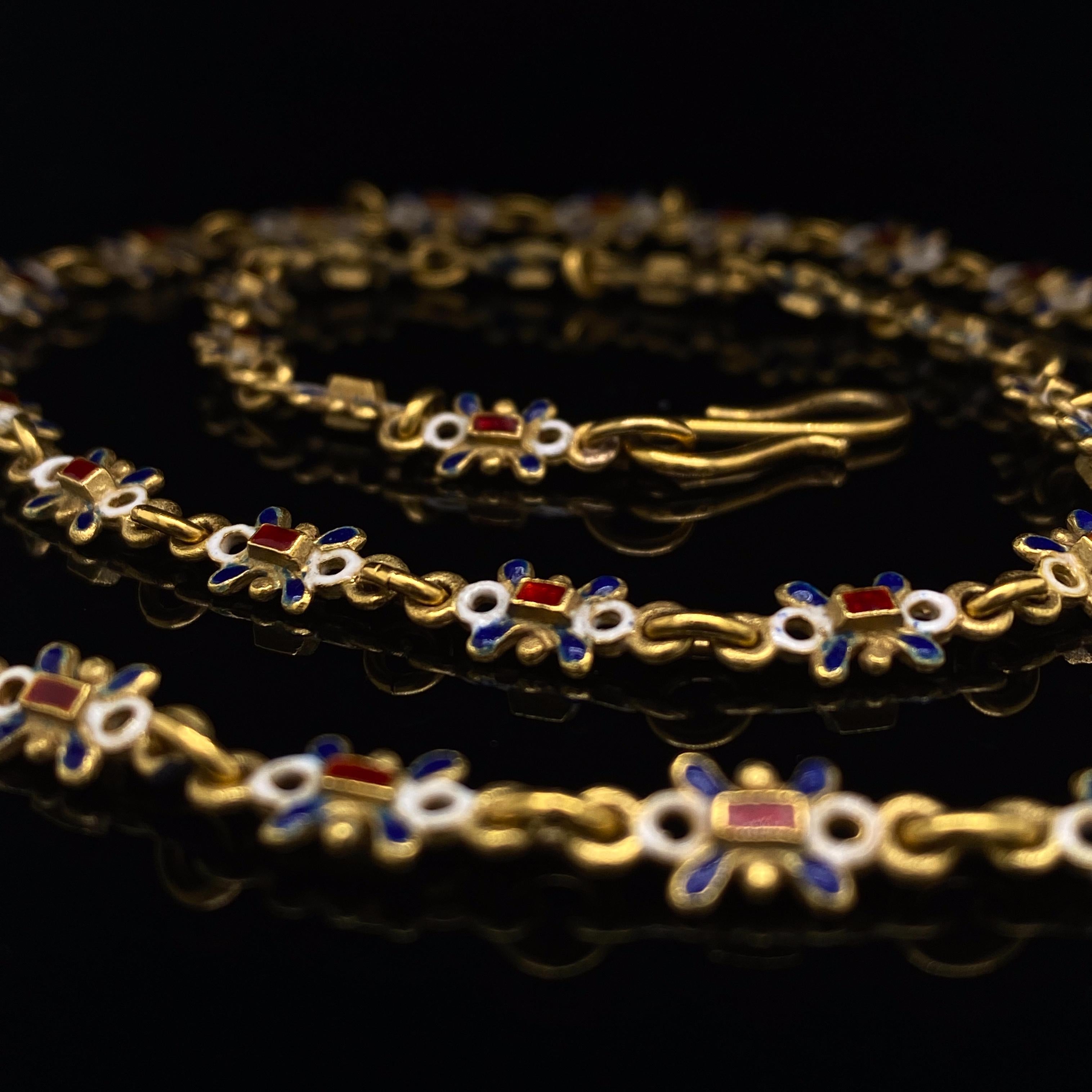 A Victorian enamel necklace 18 karat yellow gold.

The necklace is set with white, red and blue enamel floral motif links in 18ct yellow gold, circa 1900.

Such a fantastic example of Victorian enamel work with the paint work in wonderful condition,