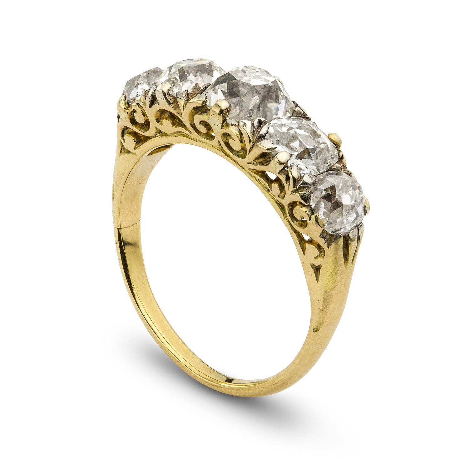 A Victorian five stone half carved hoop ring, the five graduating old brilliant-cut diamonds weighing 3.59 carats in total all set in gold to carved pierced mount, circa 1880, head measuring 0.7x2.2cm, gross weight 4.7 grams. Finger size N 1/2

This