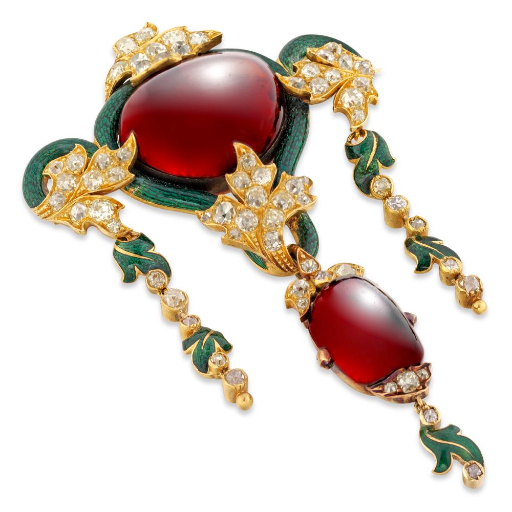 A Victorian garnet, diamond and green enamel brooch pendant, the central oval cabochon garnet, estimated to weigh 40 carats, surrounded by green enamel with four old brilliant-cut diamond-set gold leaves to each side, suspending from the centre an