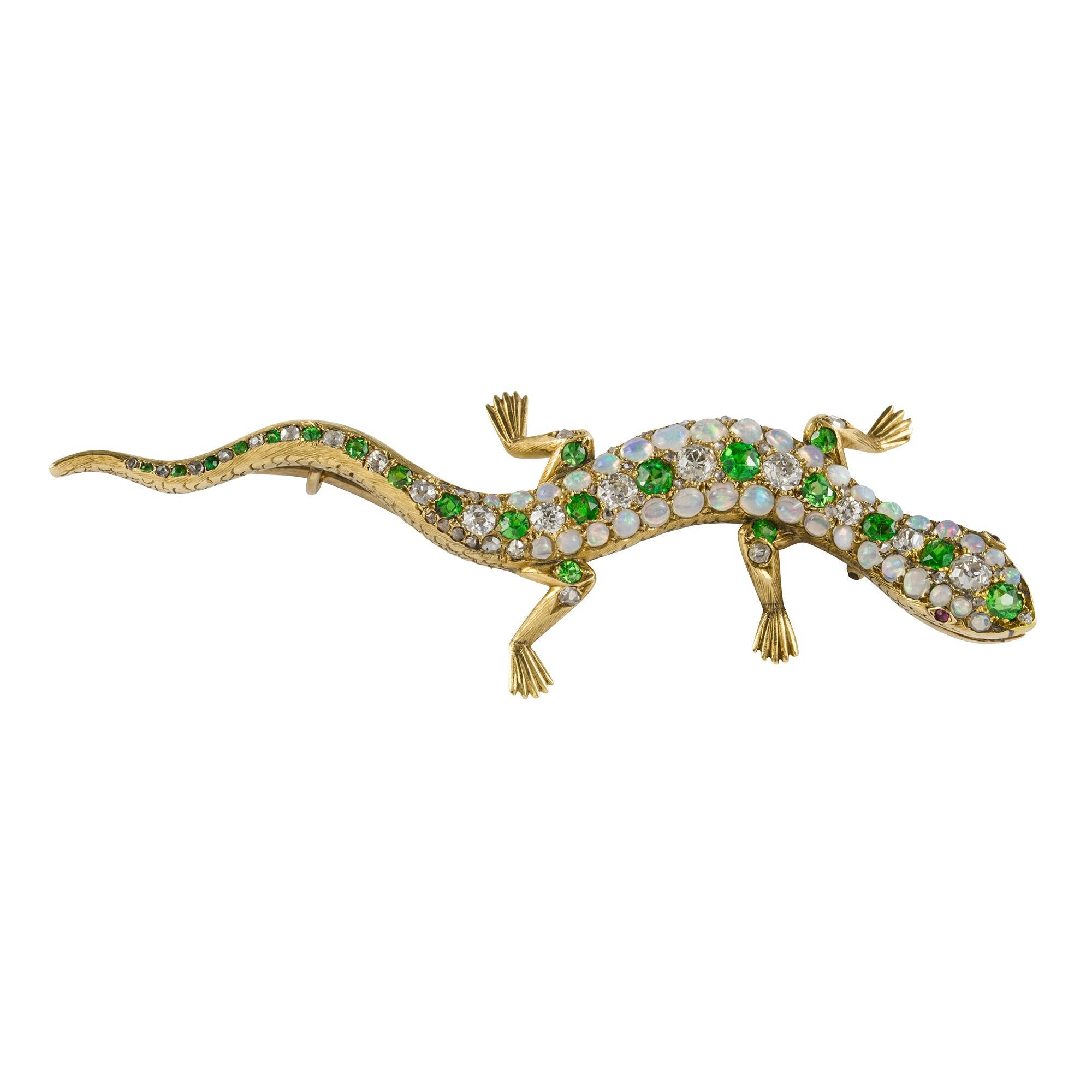A Victorian garnet, opal and diamond lizard brooch, the sinuous body set throughout with a row of alternating round faceted demantoid garnets and old brilliant-cut diamonds to the centre of two rows of cabochon-cut opals, with engraved body on the