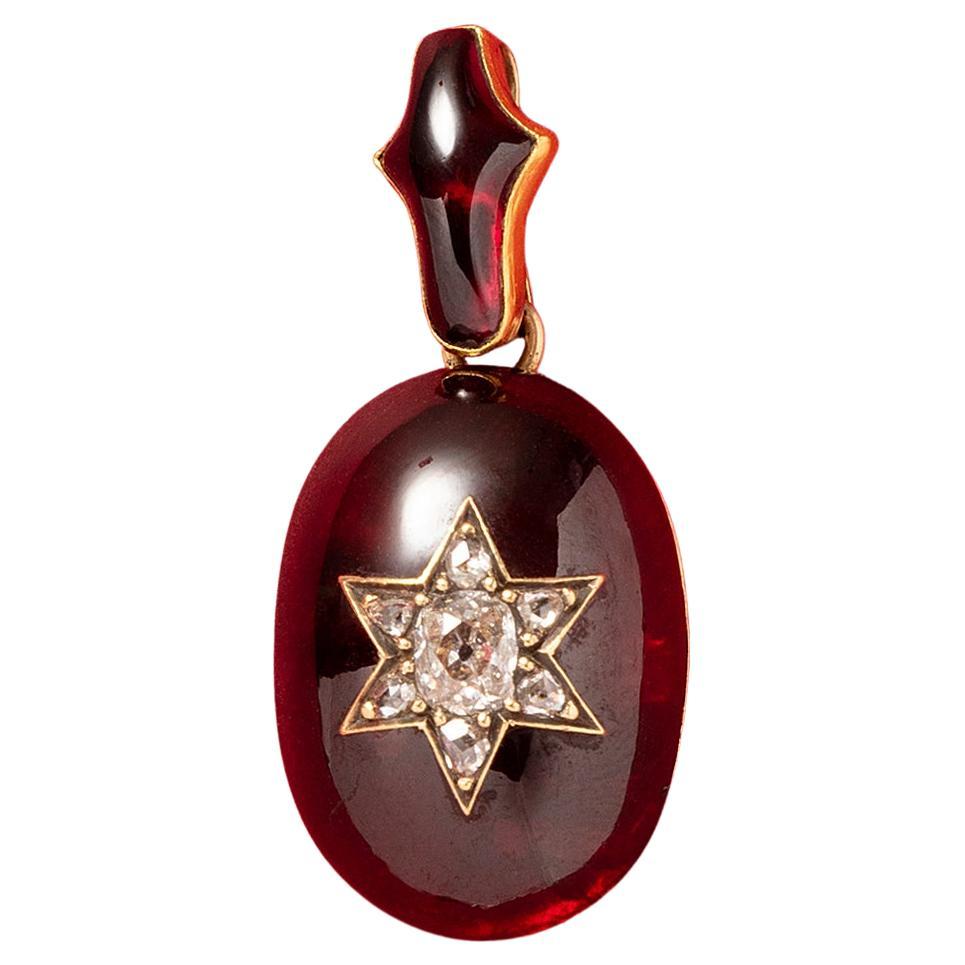 A Victorian Gold and Garnet Pendant with a Diamond Star For Sale