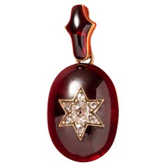 Antique A Victorian Gold and Garnet Pendant with a Diamond Star