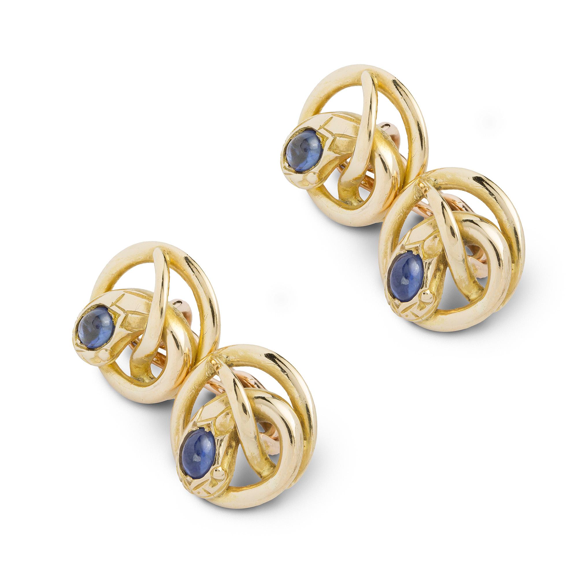 A Victorian gold and sapphire snake cufflinks, each link in the form of entwined serpent with cabochon-cut sapphire set head, linked together with gold chain, measuring approximately 1.3cm in diameter, circa 1890, gross weight 12.1 grams.

This