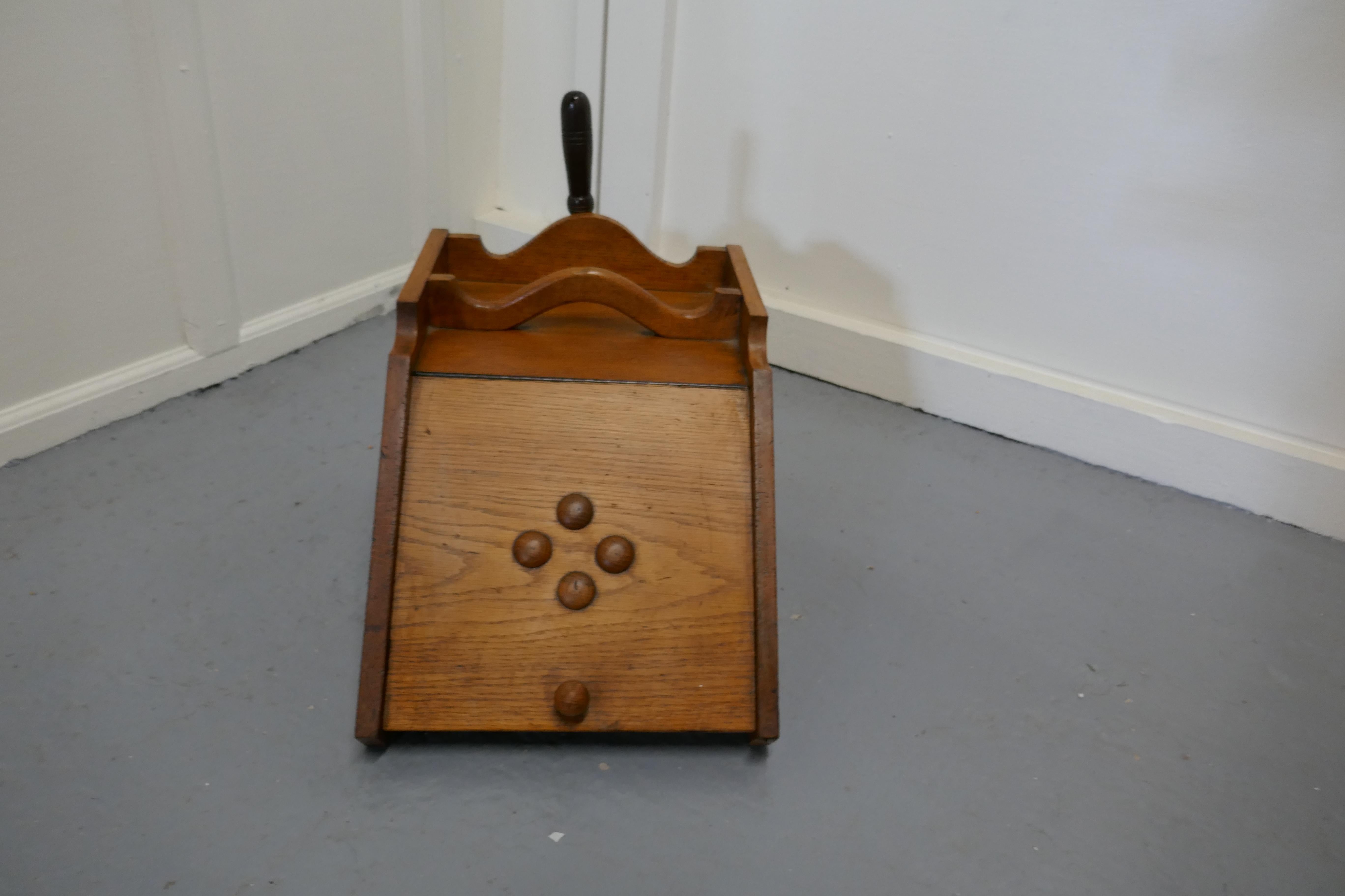 A Victorian golden ash coal box with liner and shovel

A charming piece of useful Victorian furniture
It has sloping front and a brass shovel holder in the back and inside a 2 handled metal liner
It is in good antique condition
The scuttle is