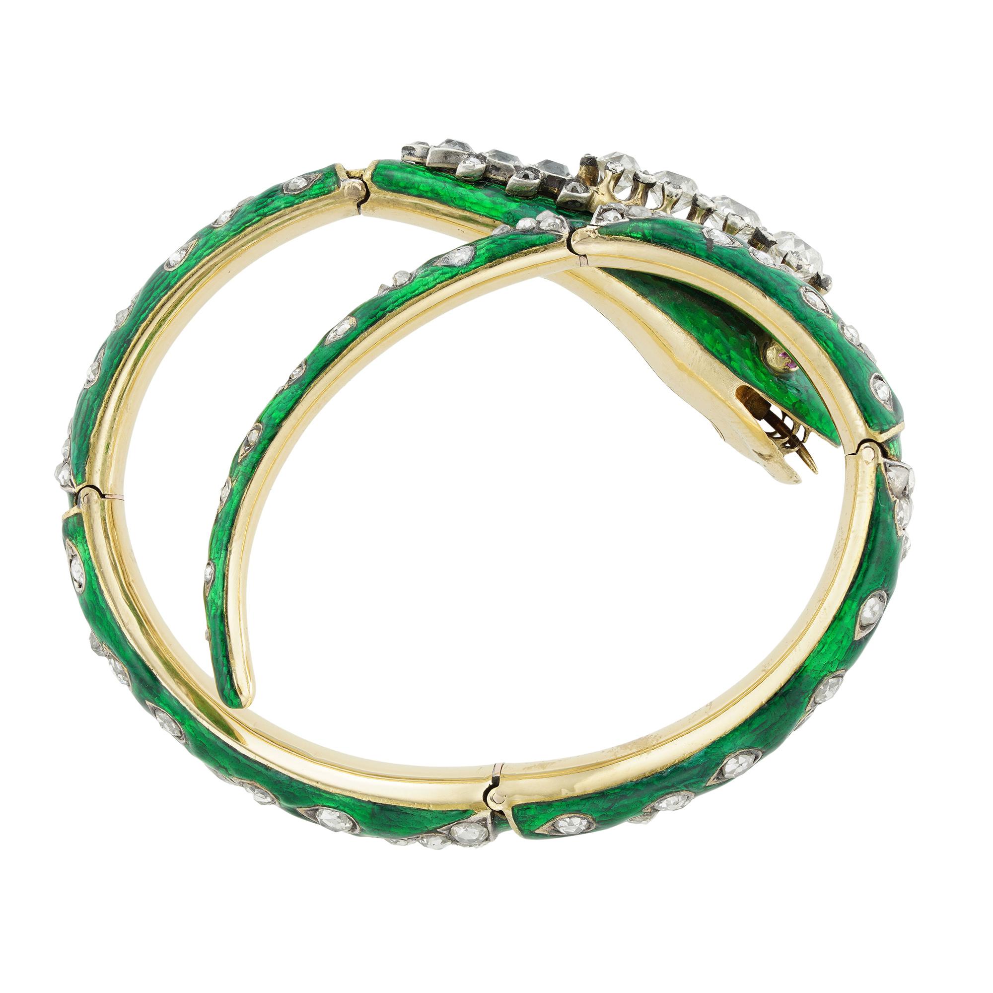 A Victorian green enamelled serpent bangle, with diamond-set head, nose and brows and cabochon ruby eyes, the tapered diamond encrusted body hinged in five places to form a wrap-around bangle, the diamonds estimated to weigh 4cts in total, circa