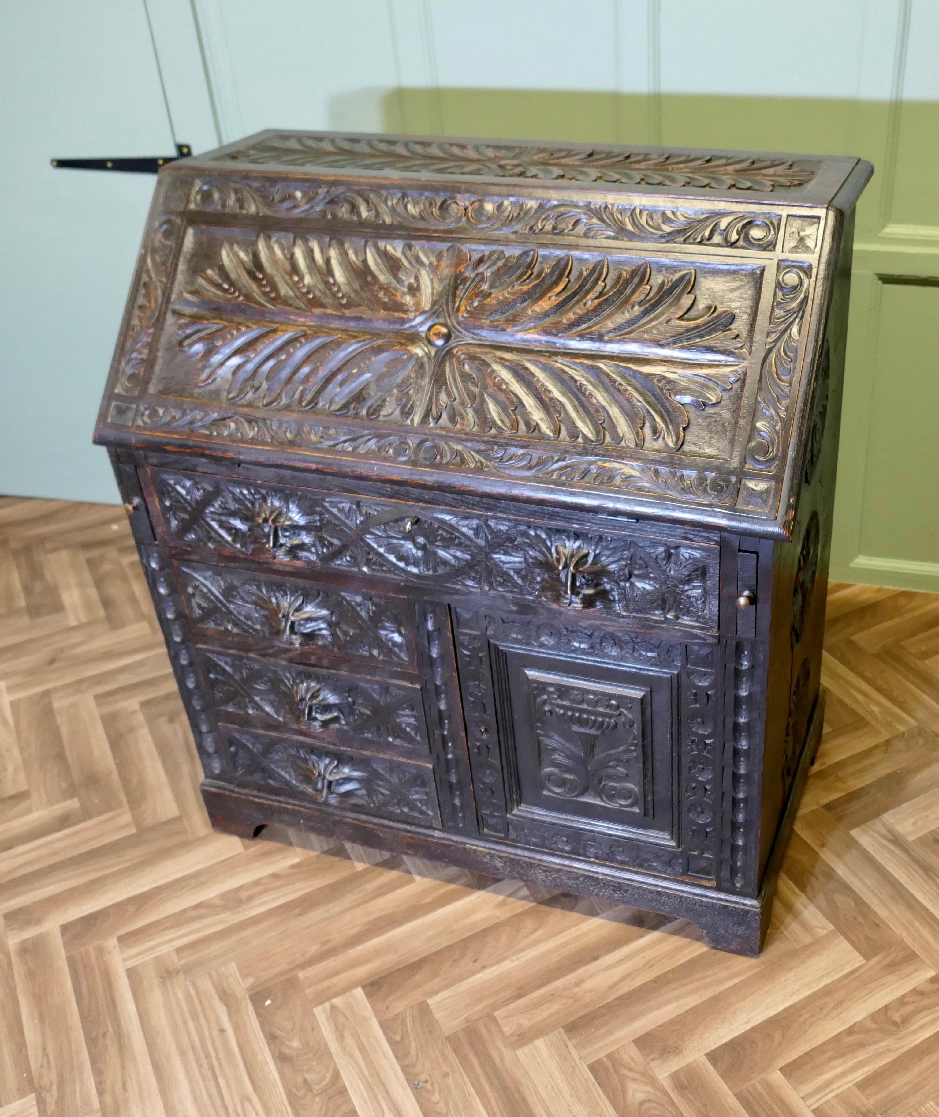 Gothique A Victorian Green Man Carved Oak Bureau   The bureau is superbly carved en vente