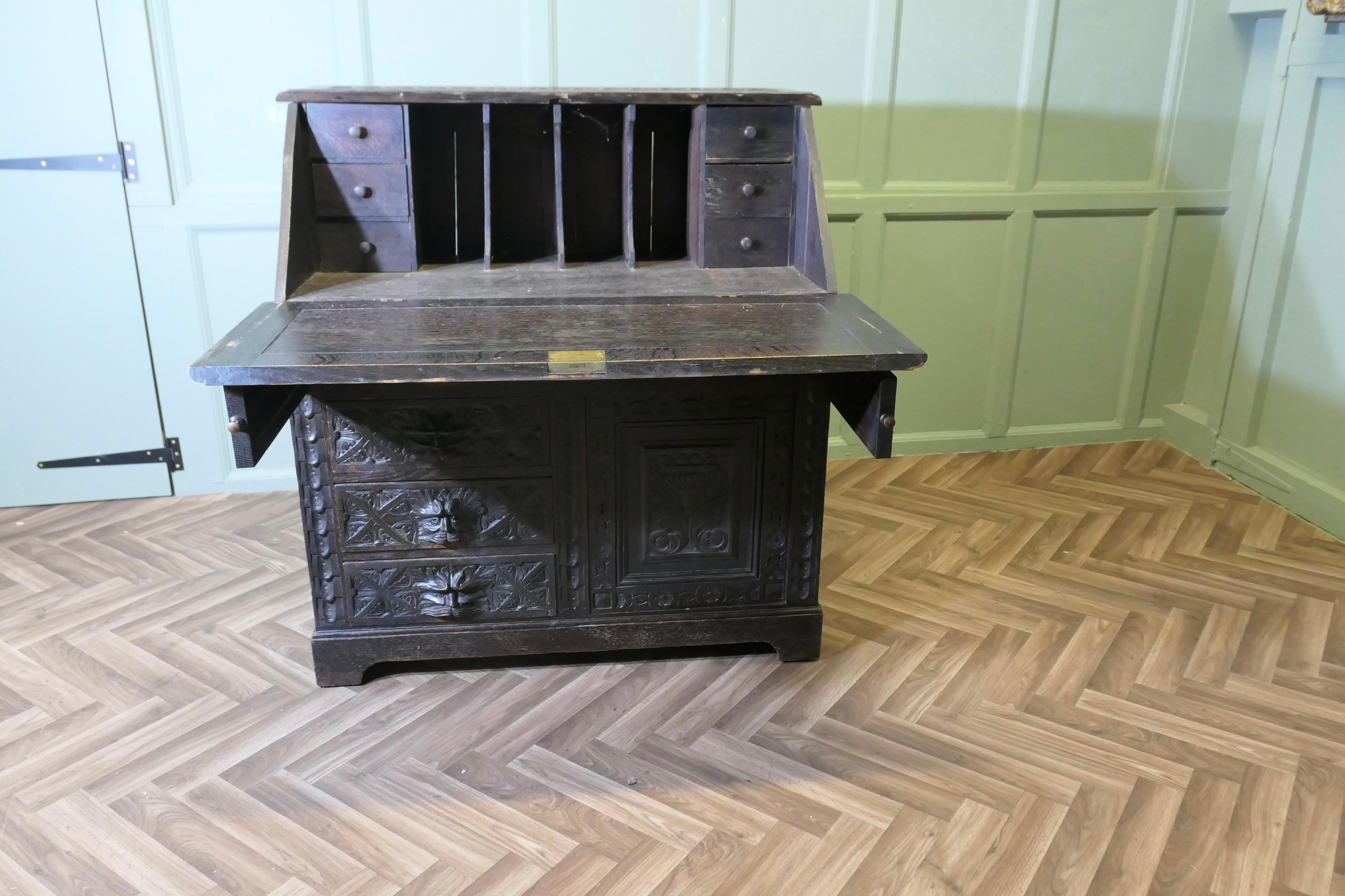 A Victorian Green Man Carved Oak Bureau   The bureau is superbly carved en vente 1