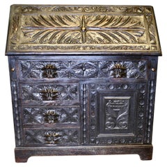 A Victorian Green Man Carved Oak Bureau   The bureau is superbly carved