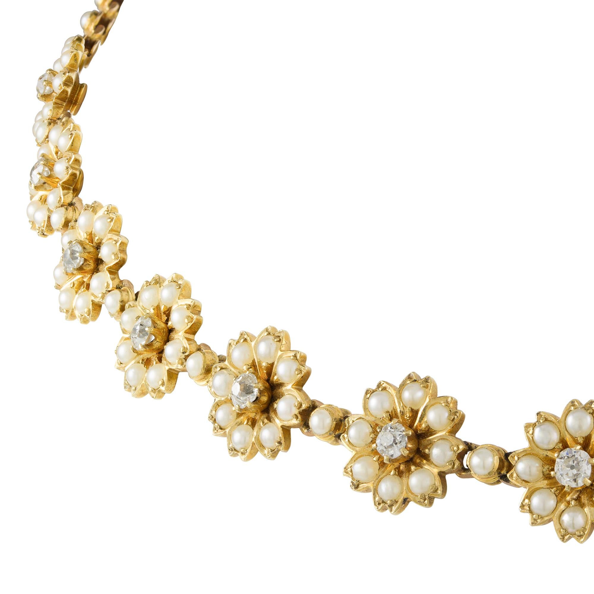 A Victorian half pearl floral necklace, consisting of eleven flower clusters each centrally-set with an old brilliant-cut diamond, the diamonds estimated to weigh 1 carat in total, to a pear-set gold chain with box clasp, all mounted in 18ct yellow