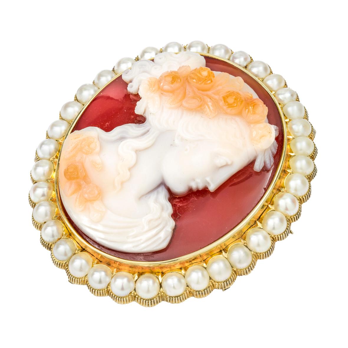 A Victorian hardstone cameo brooch, the hardstone cameo depicting a profile of lady in Roman style wearing rose wreath, surrounded by a thirty five pearls, all set in yellow gold mount with scalloped edges and brooch fitting, circa 1860, measuring