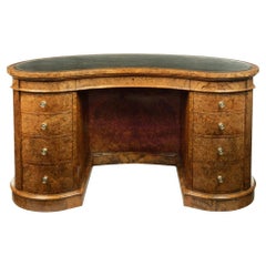 Used A Victorian kidney shaped desk in richly figured burr walnut, attributed to Gill