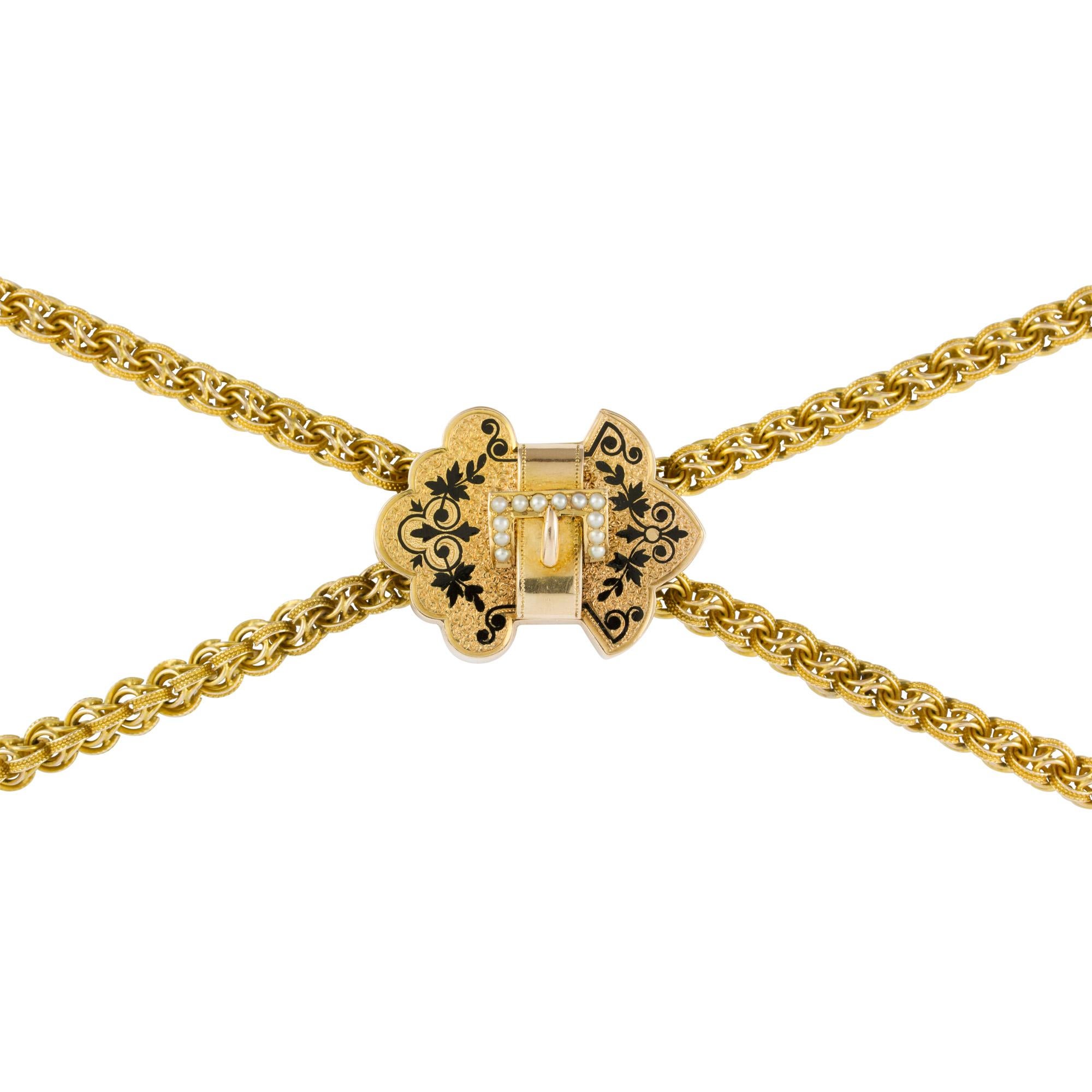 A Victorian long chain and slide, the chain of an interlocked double-link style measuring approximately 148 x 0.5cm, with an abstract slide attachment with enamel floral motif and buckle set with seed pearls, measuring approximately 2.9 x 2.2cm,
