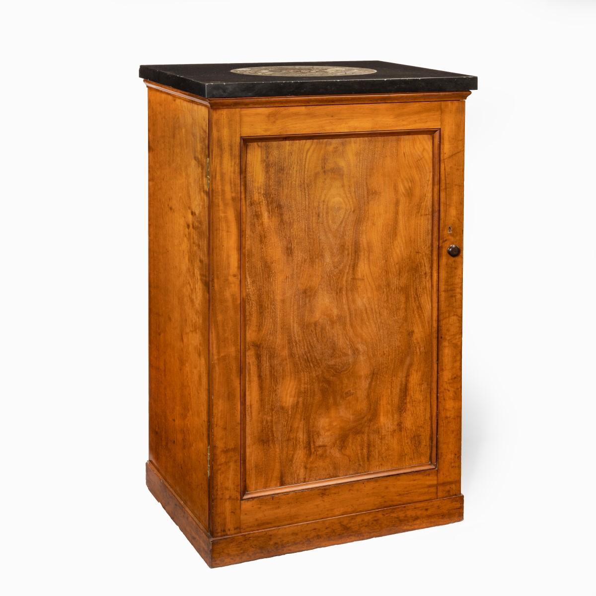 A Victorian mahogany collector’s cabinet with a fossil marble top, of rectangular form with a single panelled door opening to reveal 13 drawers, the black marble top set with a large central nautiloid, with the original key. English, circa