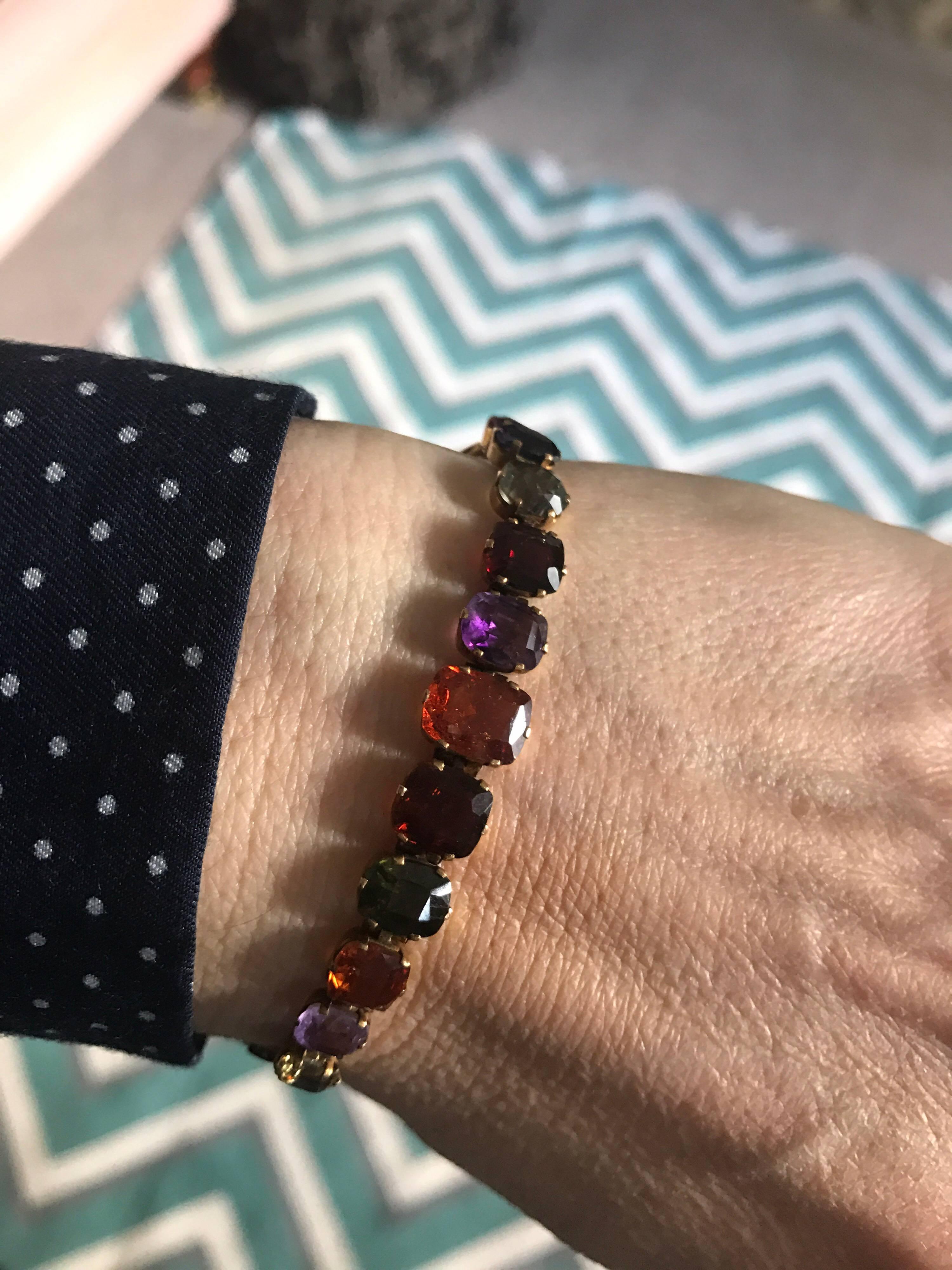 A Late Victorian early 20th Century multi gem, sometimes called harlequin bracelet, set in 9 karat gold, with a variety of different gems, purple and pink sapphire, amethyst, citrine, hessonite garnet, garnet, peridot, zircon. Although it is not