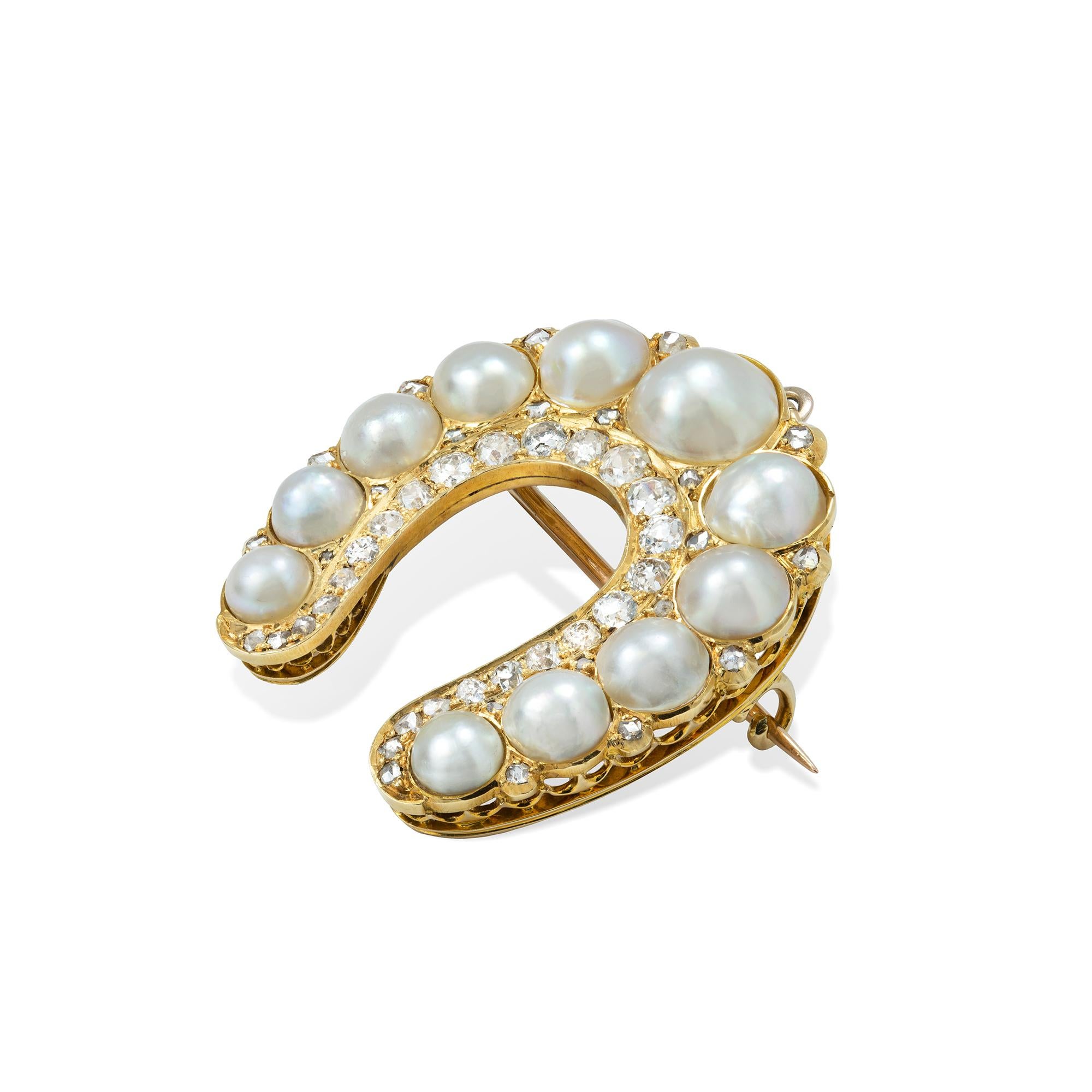 A Victorian natural pearl and diamond horseshoe brooch/pendant, the eleven pearls graduating from the centre, accompanied by GCS Report 77109-41 stating to be natural half-pearls of saltwater origin, flanked with twenty rose-cut diamonds, with an