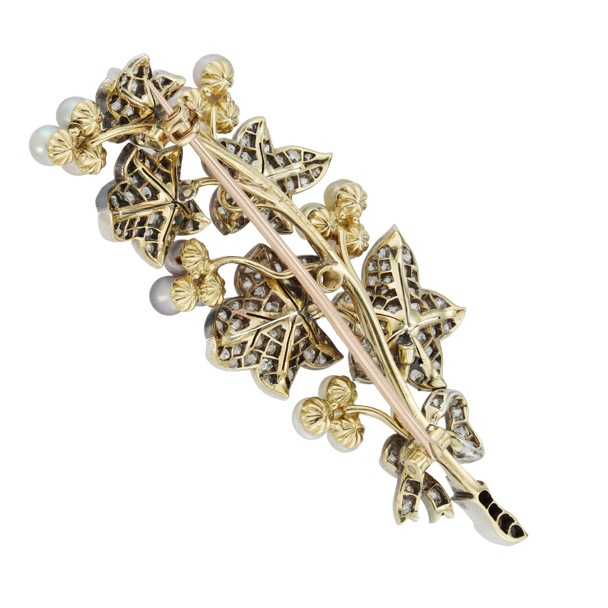 A Victorian natural pearl and diamond ivy spray brooch, consisting of  five leaves encrusted with small old-mine cut diamonds and flanked with five natural peal-set clovers, each clover set with a different colour pearls, accompanied by GCS report