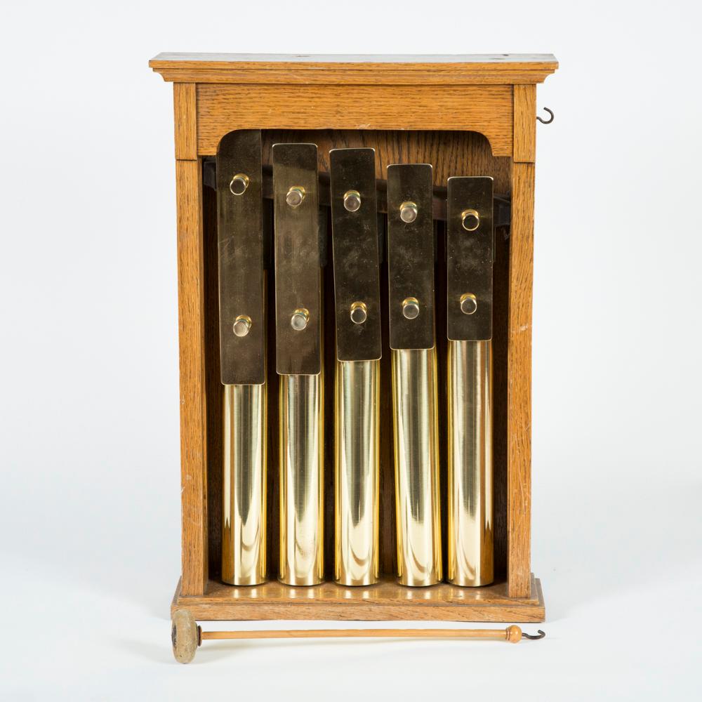 A Victorian oak cased set of five gongs, with beater.