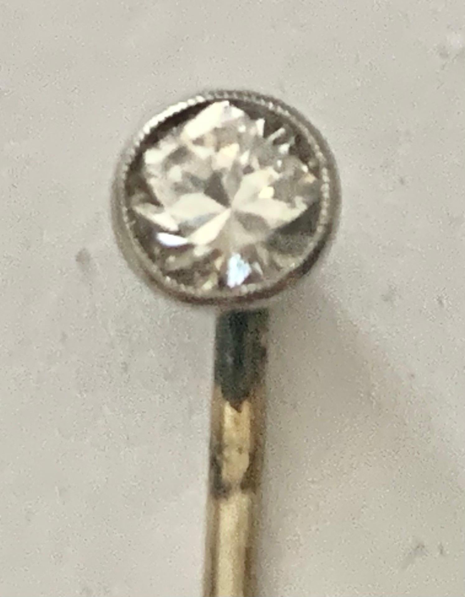 A Circa: Early 20th century. 
This stickpin is made in 18tk white gold and platinum. The head is set with an old brilliant cut diamond weighing approximately 0.45ct. It is set secured with rub over millegrain setting. The diamond is Color: I/J •