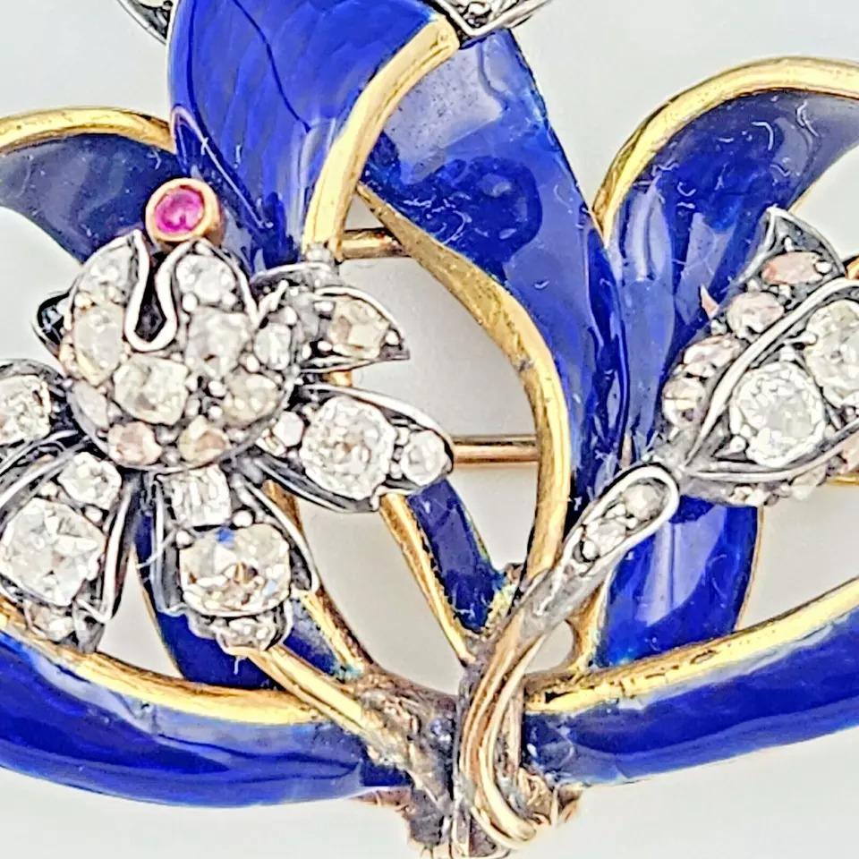 Add a touch of timeless elegance to your collection with this exquisite Victorian-era brooch. Crafted circa 1880, it features a stunning blend of rich yellow gold, blue enamel, and an old cut diamond. This piece is a beautiful representation of