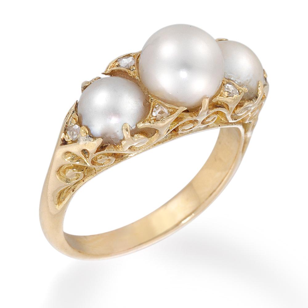 A Victorian pearl and diamond ring, the three graduated natural pearls, centre weighing 1.55ct, set into a carved gold mount embellished with rose cut diamond points, total estimated diamond weight 0.9 carats, hallmarked 18ct gold, circa 1870, the