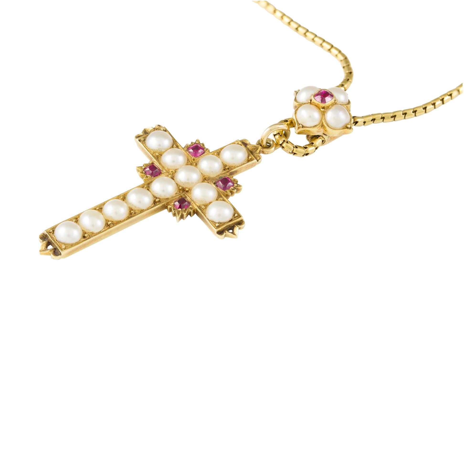 A Victorian pearl and ruby cross, the body and the arms set with twelve half pearls embellished with four rubies, on chain with pearl and ruby flower slide, all mounted in yellow gold, circa 1880, the cross measuring approximately 2.7 x 2.4cm, the